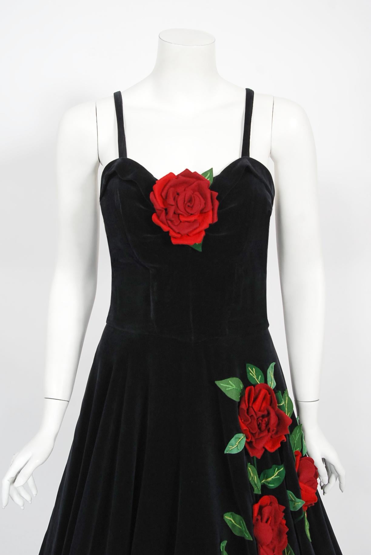 An absolutely stunning 1950's red roses floral appliqué black velvet dress from the iconic California couturier Juli Lynne Charlot. Not many people know Juli Lynne Charlot was an actress turned designer. In 1947, she designed a felt circle-skirt