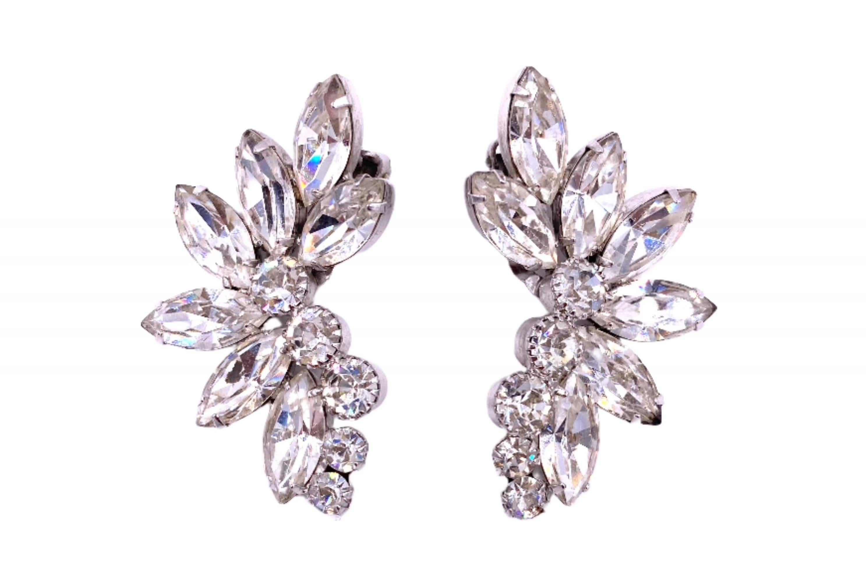 Indulge in vintage elegance with our 1950's Large Crystal Clip-On Earrings. Made with dazzling crystals, these clip-ons exude sophistication and luxury. Add a touch of timeless glamour to any outfit with these exclusive earrings. No piercings? No