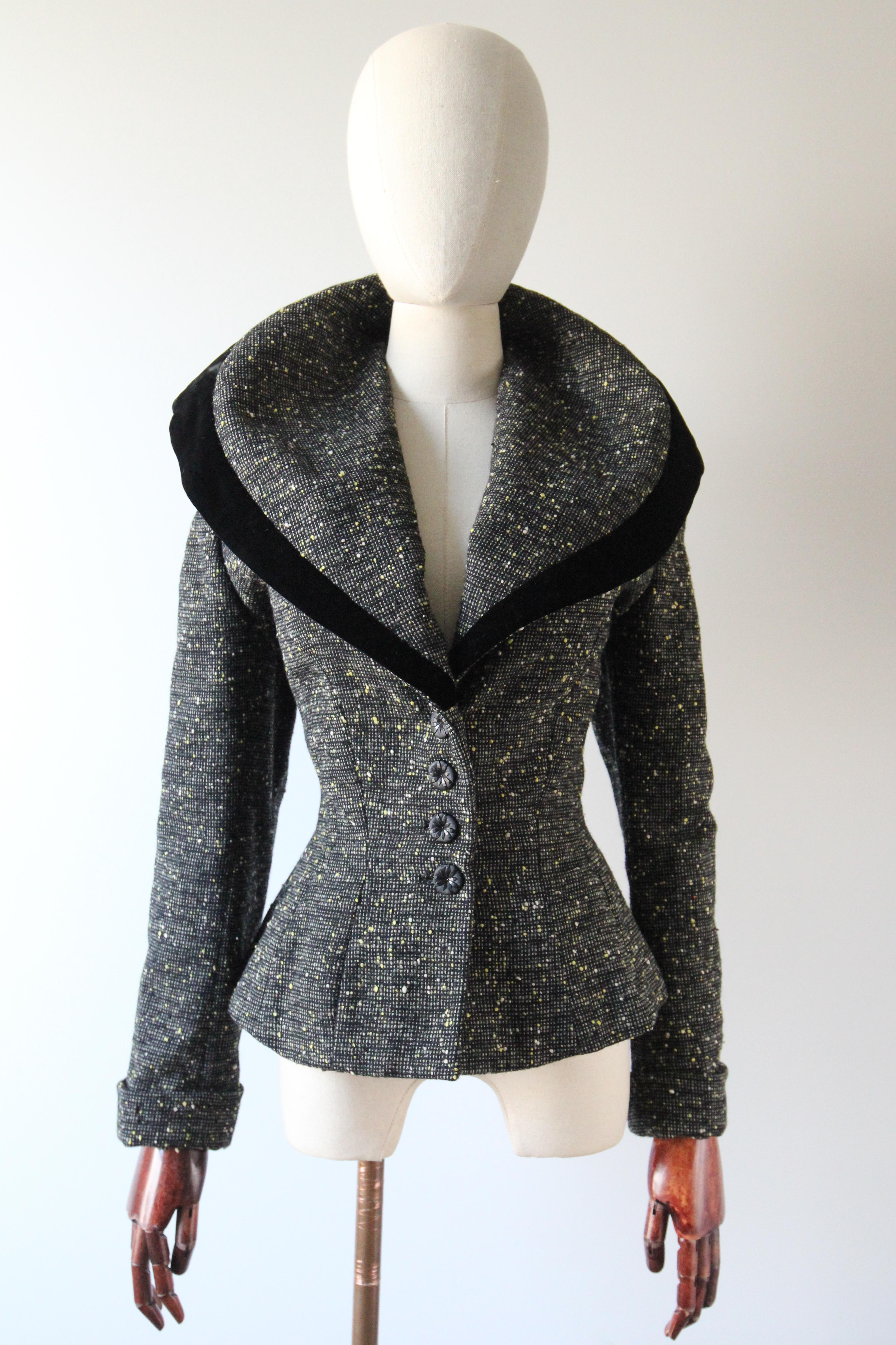 This incredibly tailored black and grey checkered wool 1950's Lilli Ann Jacket, with a speckled wool pattern in shades of bright yellow and grey, set off by a black velvet accent, is just the piece to welcome the cooler weather with. 

The V shaped