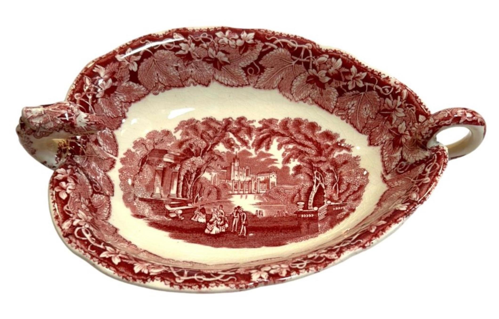 This 1950’s Mason’s serving dish is a rare find for collectors.  The charming red color and dragon design make is a unique addition to any collection.  It features the head of a dragon at one end and the tail at the other to form the handle, resting