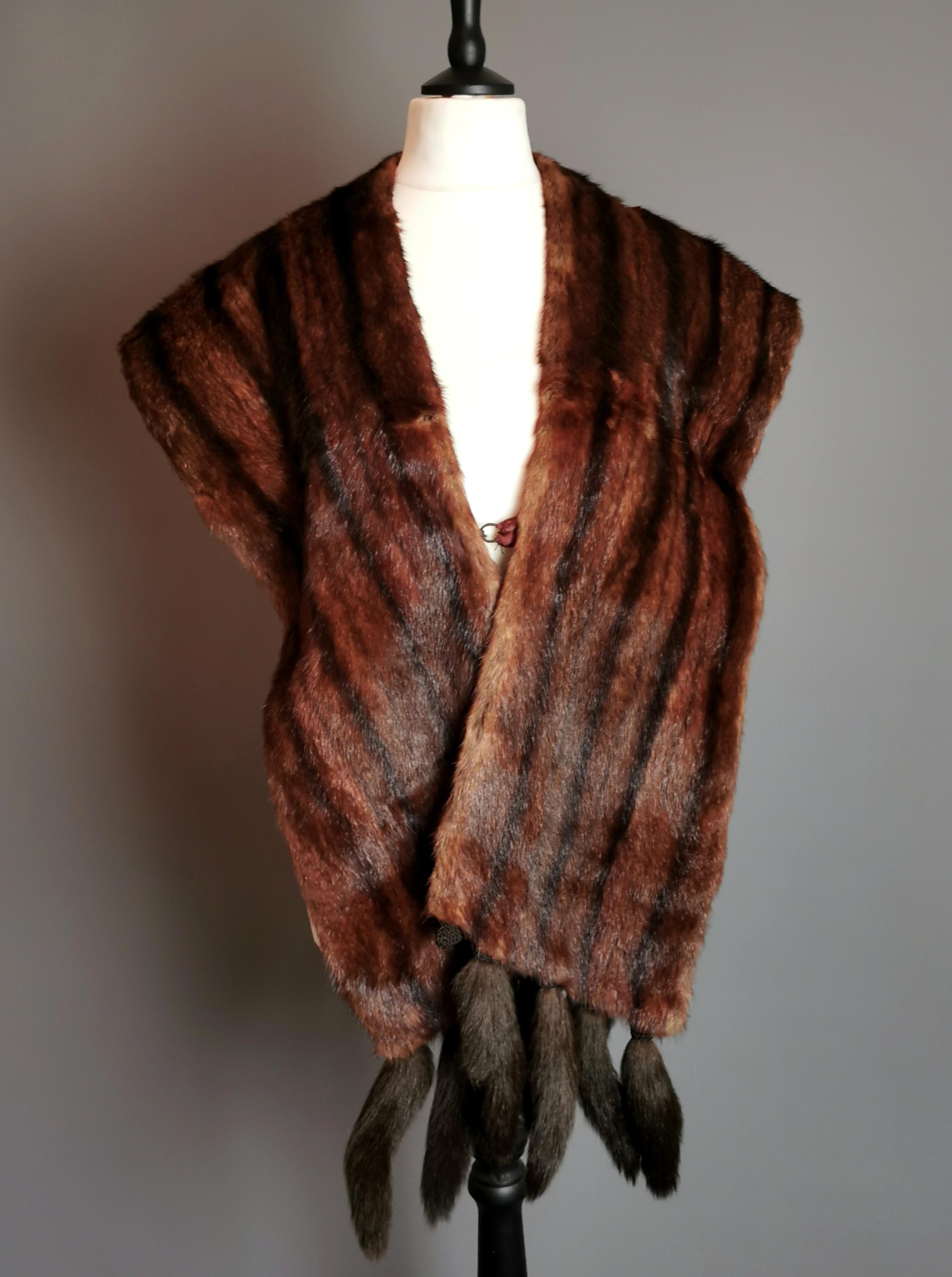 A beautiful vintage c1950s soft real mink fur stole.

It is a large and luxurious stole, made with high quality super soft mink fur in mahogany brown with black stripes, the stole has tails, one is missing.

The stole is lined in a rich rust