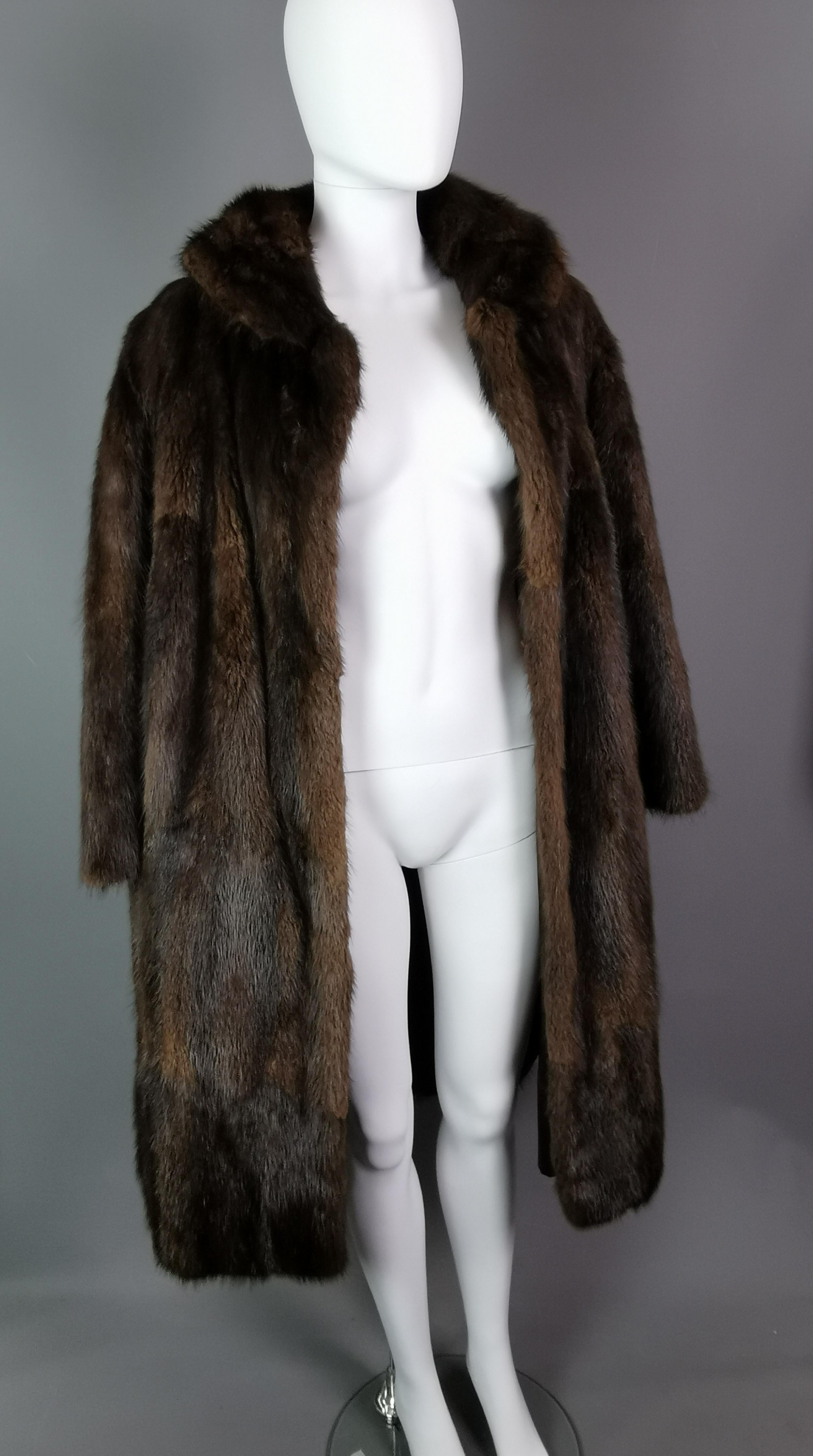 A very fine, high quality vintage mink fur swing coat.

It is made from mahogany brown and black mink fur, superbly soft and lined in a chocolate brown satin.

It has a nice wide collar.

It has no fasteners and is labelled Kendal Milne, Kendal