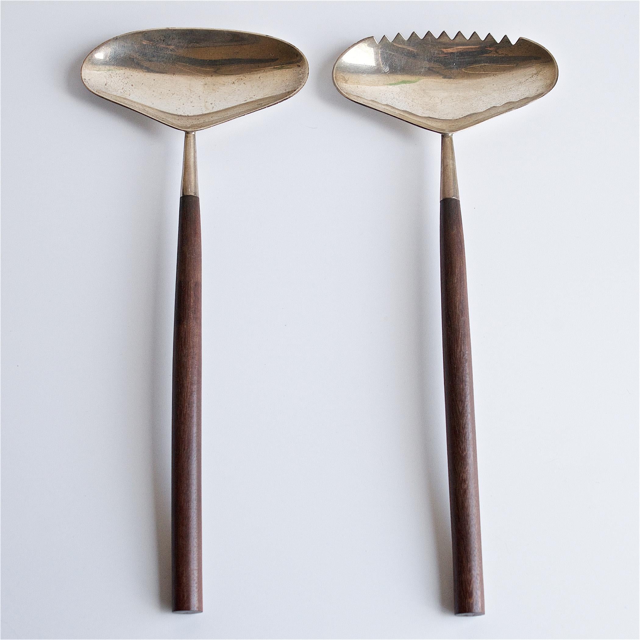 Unknown designer, but the sterling is marked, with Moderna Sterling Mexico Artist Mark, and the Mexico state Eagle 1 stamp. The Hardwood handles are Ebony, or Rosewood.
