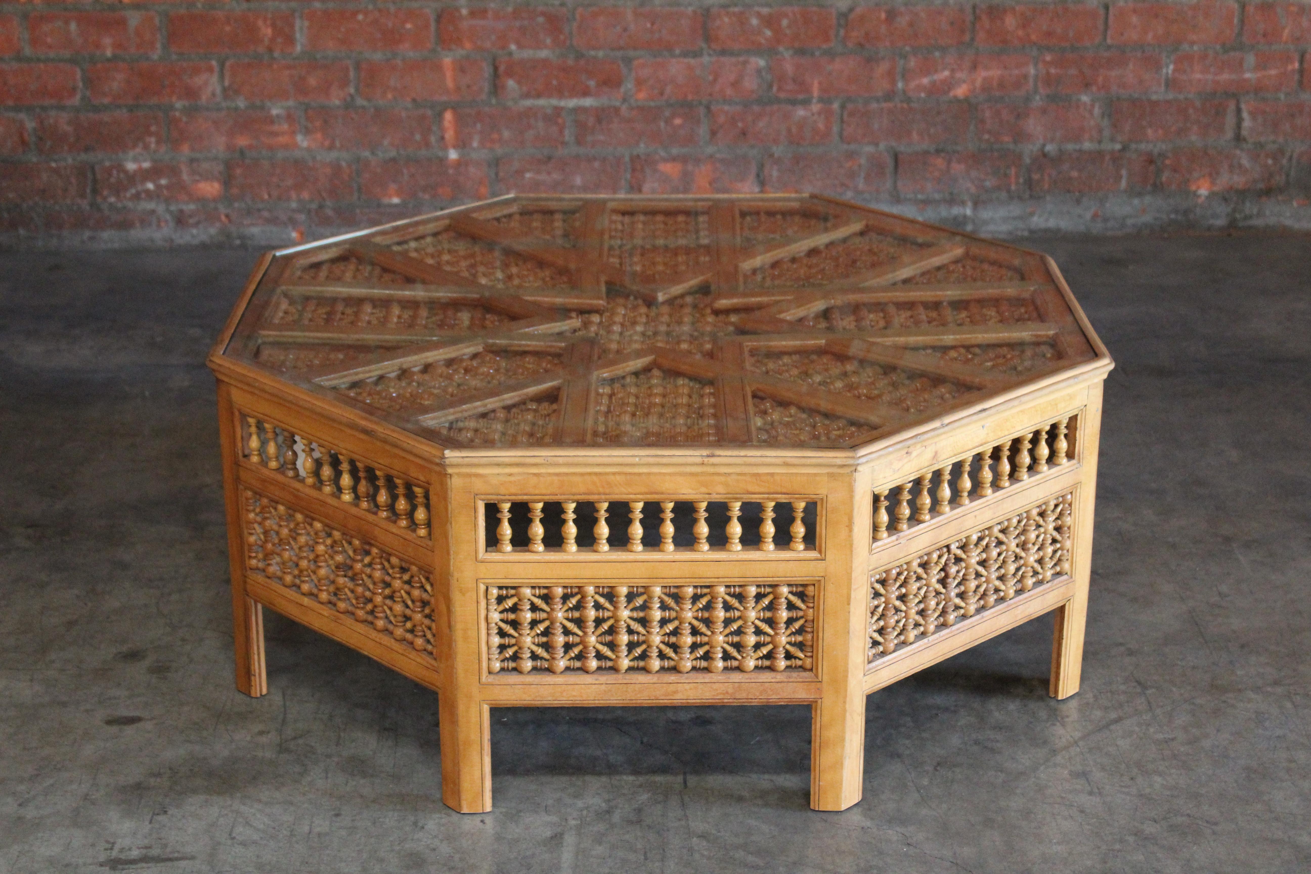 A vintage octagonal Moorish style coffee table, 1950s. New glass top. In excellent condition.