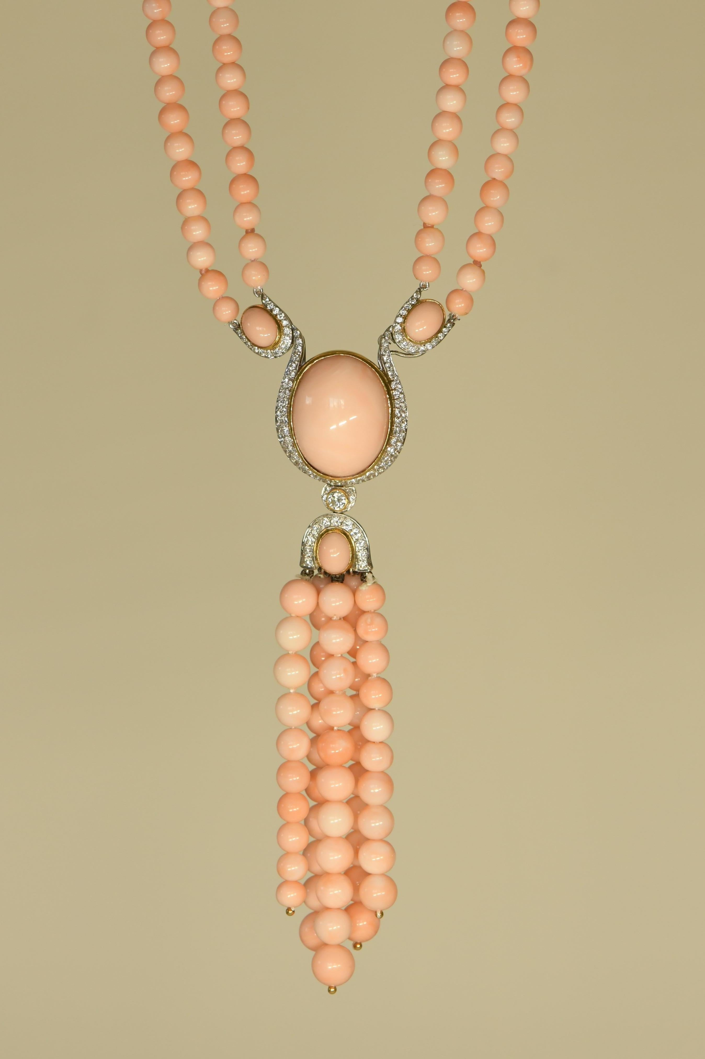 This is a lovely multi-strand vintage Pink Peach Coral Necklace with a Coral Pendant featuring large cabochon Coral separating the multi coral strands for a really elegant look. 

The luscious and glossy gems from the sea are a deep pink peachy