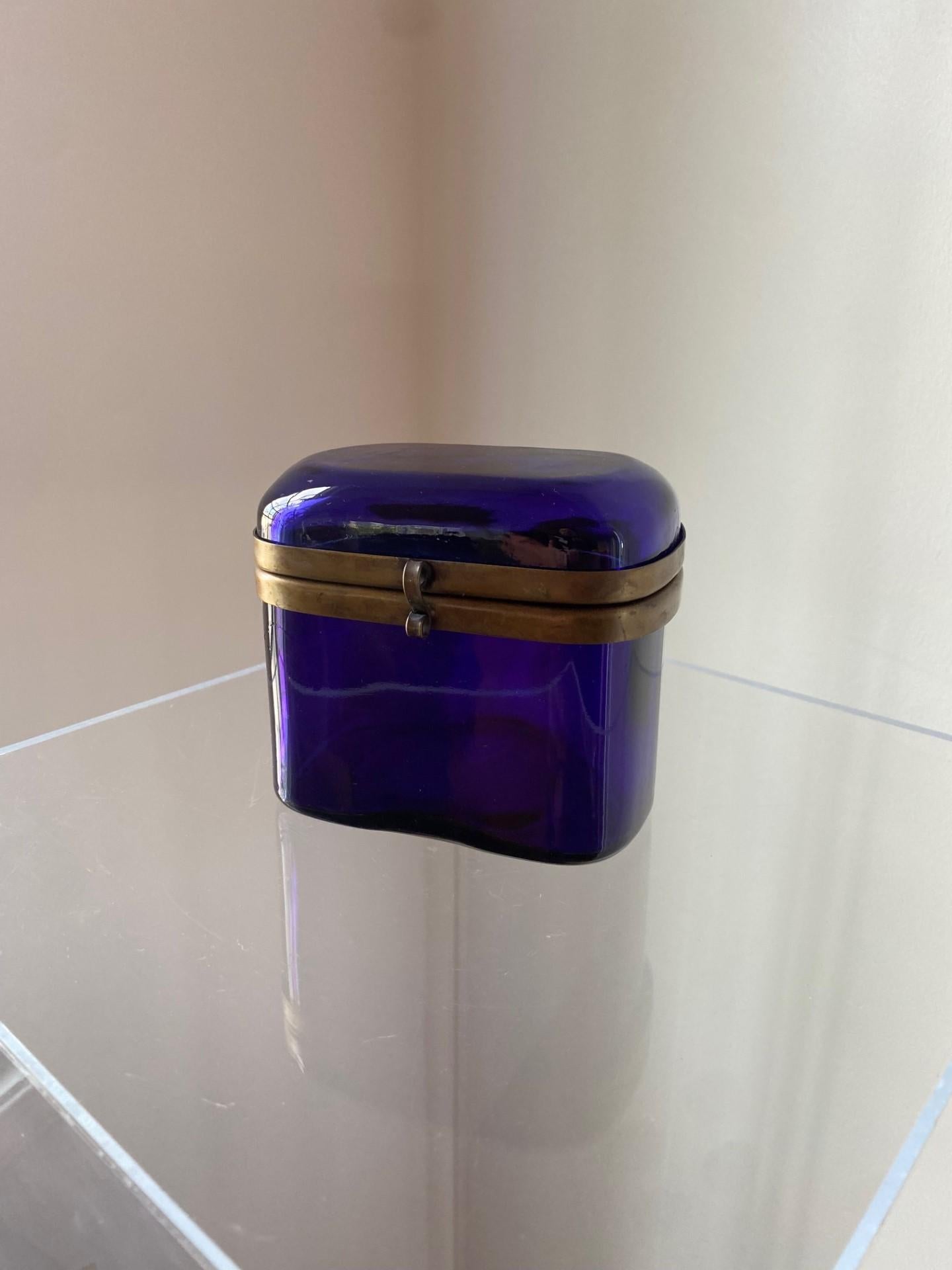 Vintage and rare murano glass box with brass detail.  These beautiful glass boxes are treasured objects that stand the test of time with their incredible beauty and craftmanship.  Created in a beautiful cobalt blue glass, this piece is emphasized by