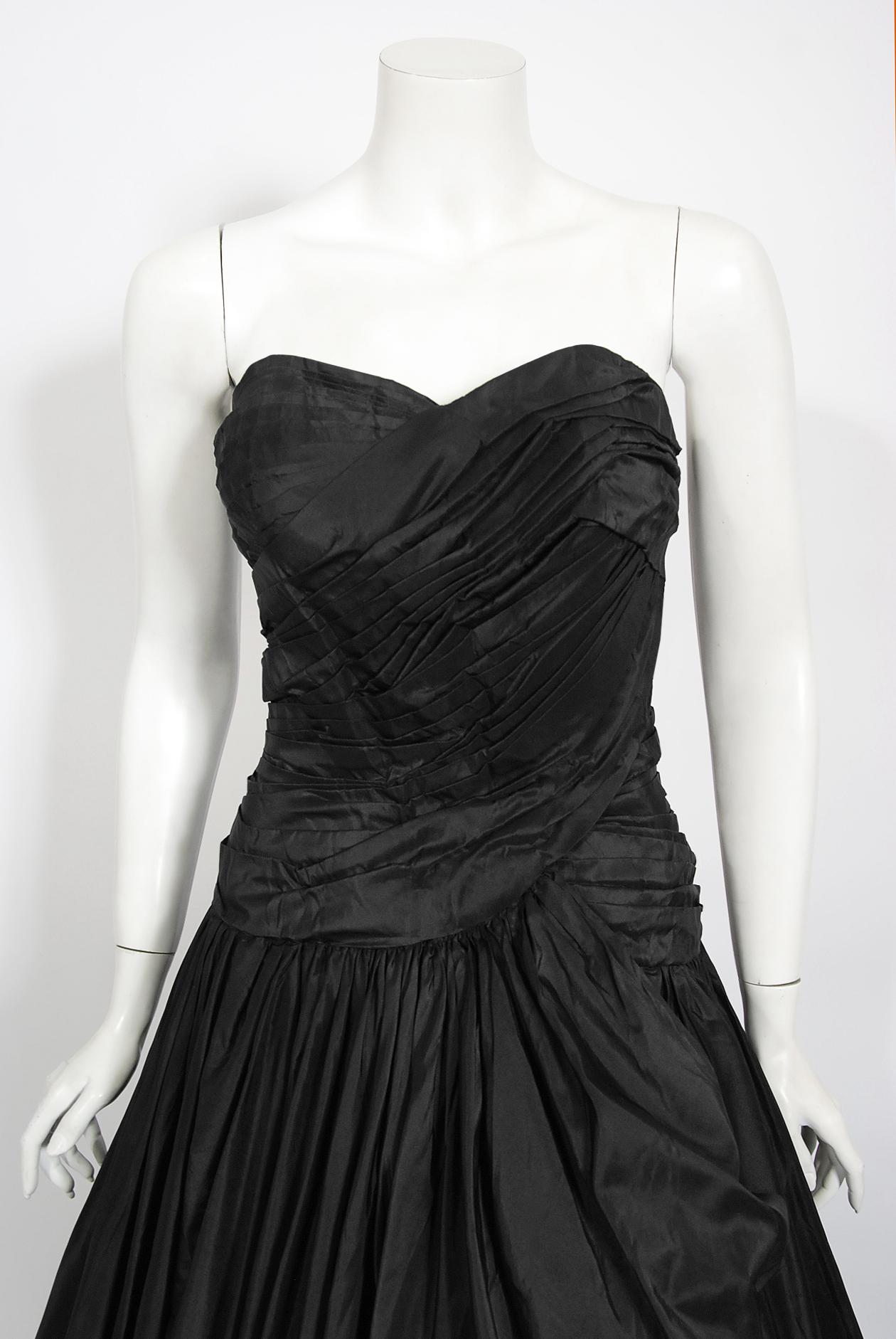 In this sensational Nanty Couture black silk taffeta sculpted voluminous ballgown, the detailed construction and meticulous attention to detail are comparable to what you will find in modern day haute couture. This custom garment even still has her
