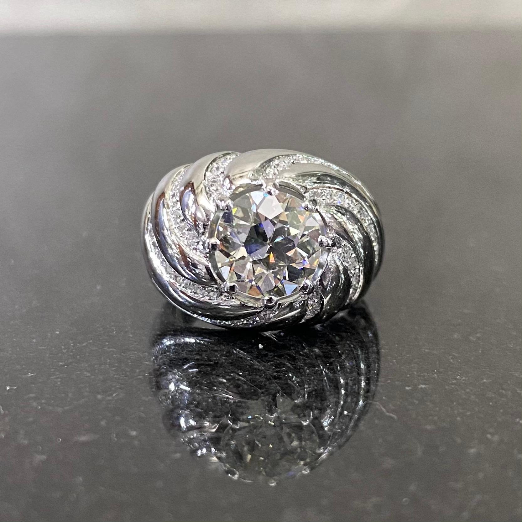 A vintage Old European brilliant-cut diamond spiraled bombe cocktail ring in platinum, Portuguese, 1950s. This mid-20th century ring of a bombe design features an Old European brilliant-cut diamond eight claw-set to the center and is further