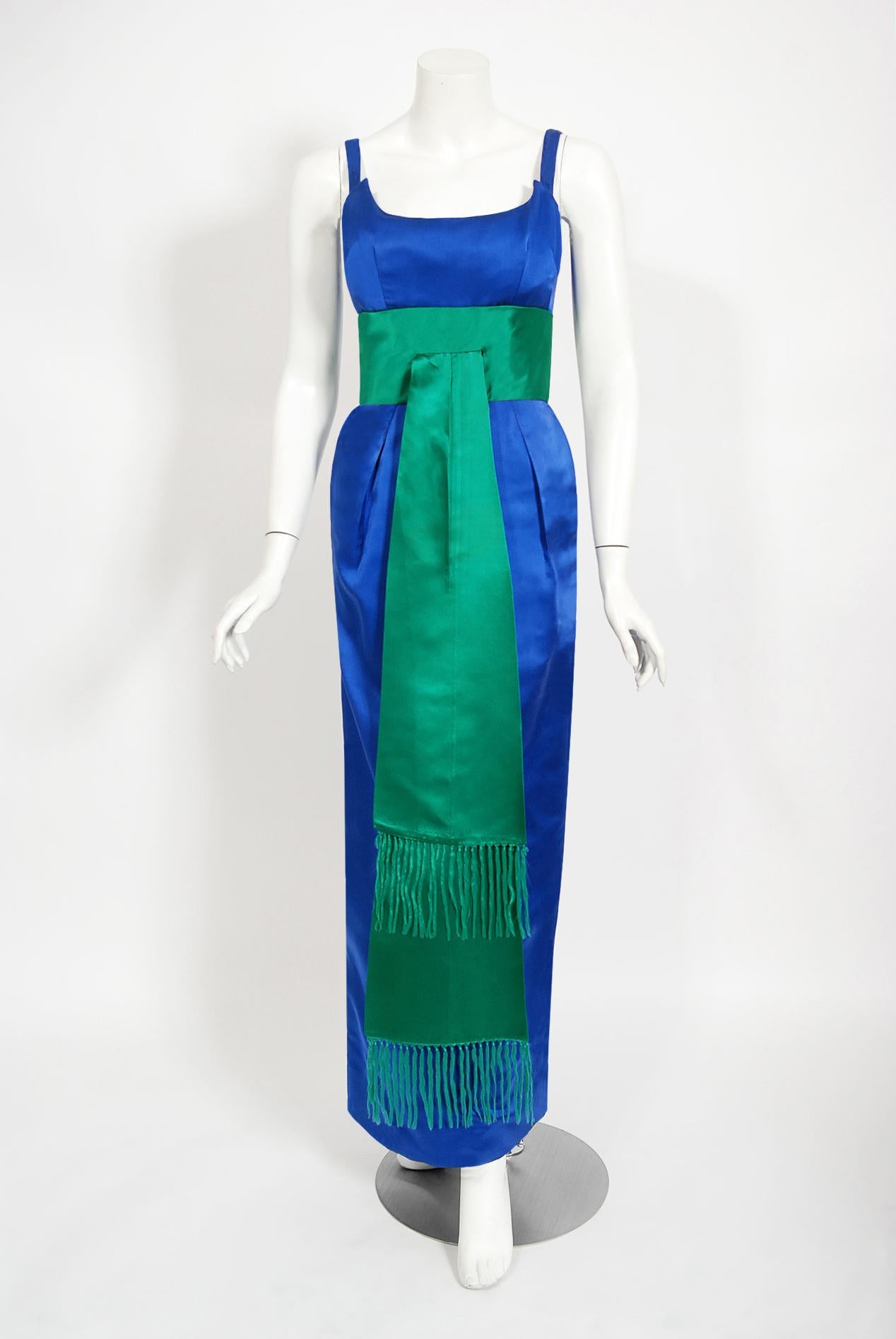 Sensational Oleg Cassini sapphire blue and emerald green sculpted hourglass gown dating back to the late 1950's. Oleg Cassini was a French-born American fashion designer who dressed numerous stars, creating some memorable moments in celebrity