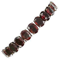 Bracciale tennis ovale con granati degli anni '50, in oro giallo 12k