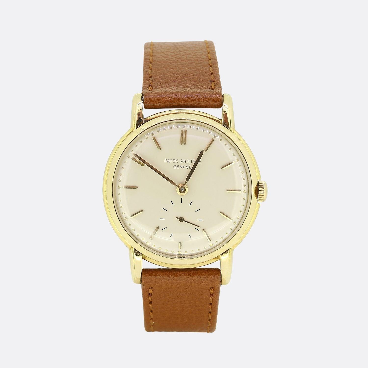 This is a vintage 18ct yellow gold gents Patek Philippe wristwatch. The watch dates back to the mid to late 1950s and features a silver dial with gold hour and minute hands and a small seconds hand at 6 oclock. This case is 18ct yellow gold and has