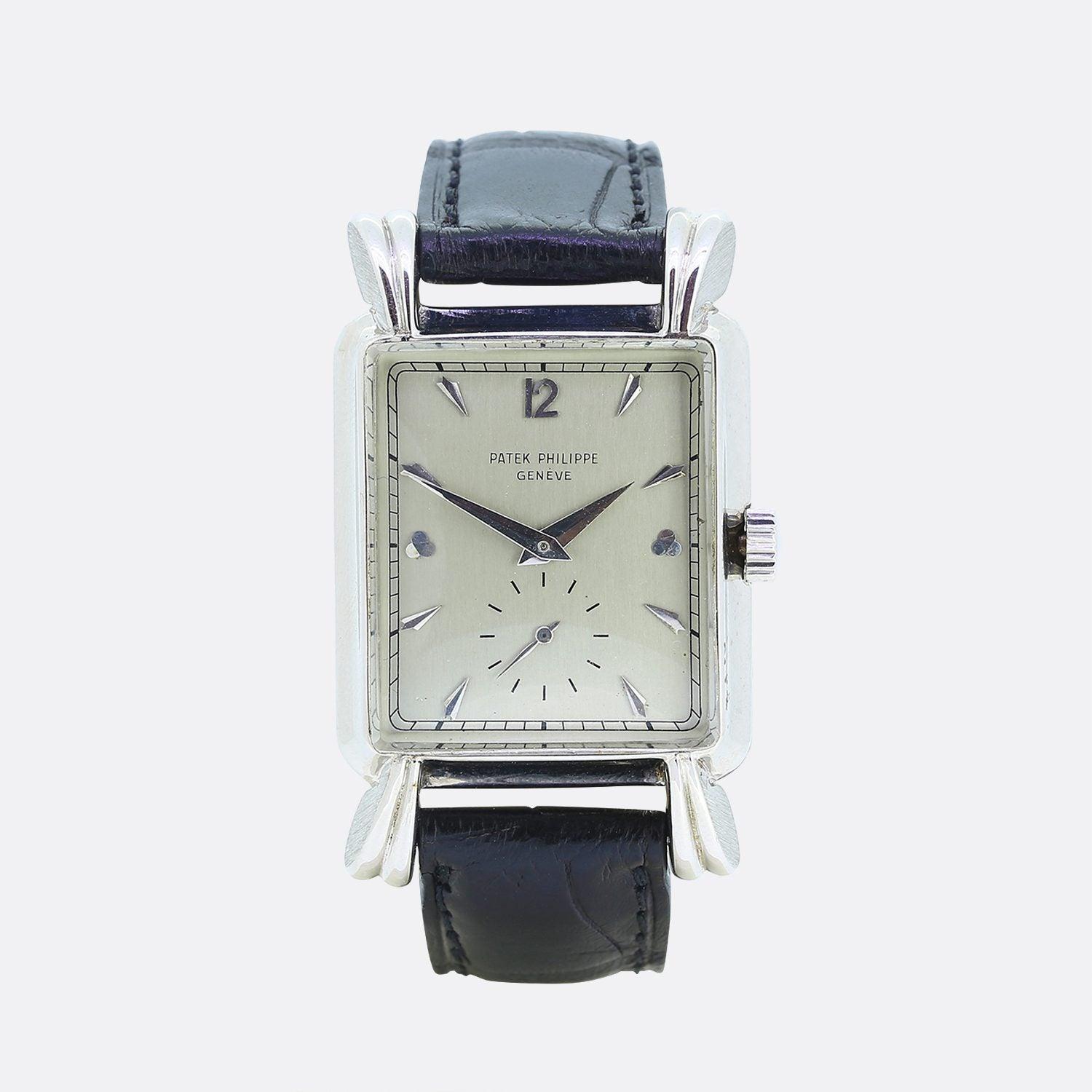 This is a wonderful 1950s gents Patek Philippe wristwatch. The watch features a silver dial with white hour and minute hands and a seconds subdial at 6 o'clock. The fluted overhanging tear drop lugs on the large vertical rectangular case with