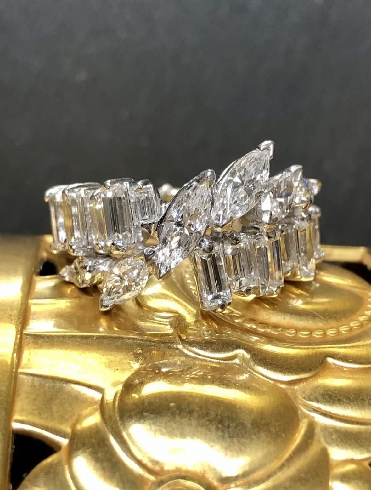 A timeless band done in platinum circa the 1950’s set all the way around with alternating sizes baguettes and centered by larger marquise cut diamonds. Total approximate diamond weight is 4.20cttw and all stones are G-J color and Vs1-Si2