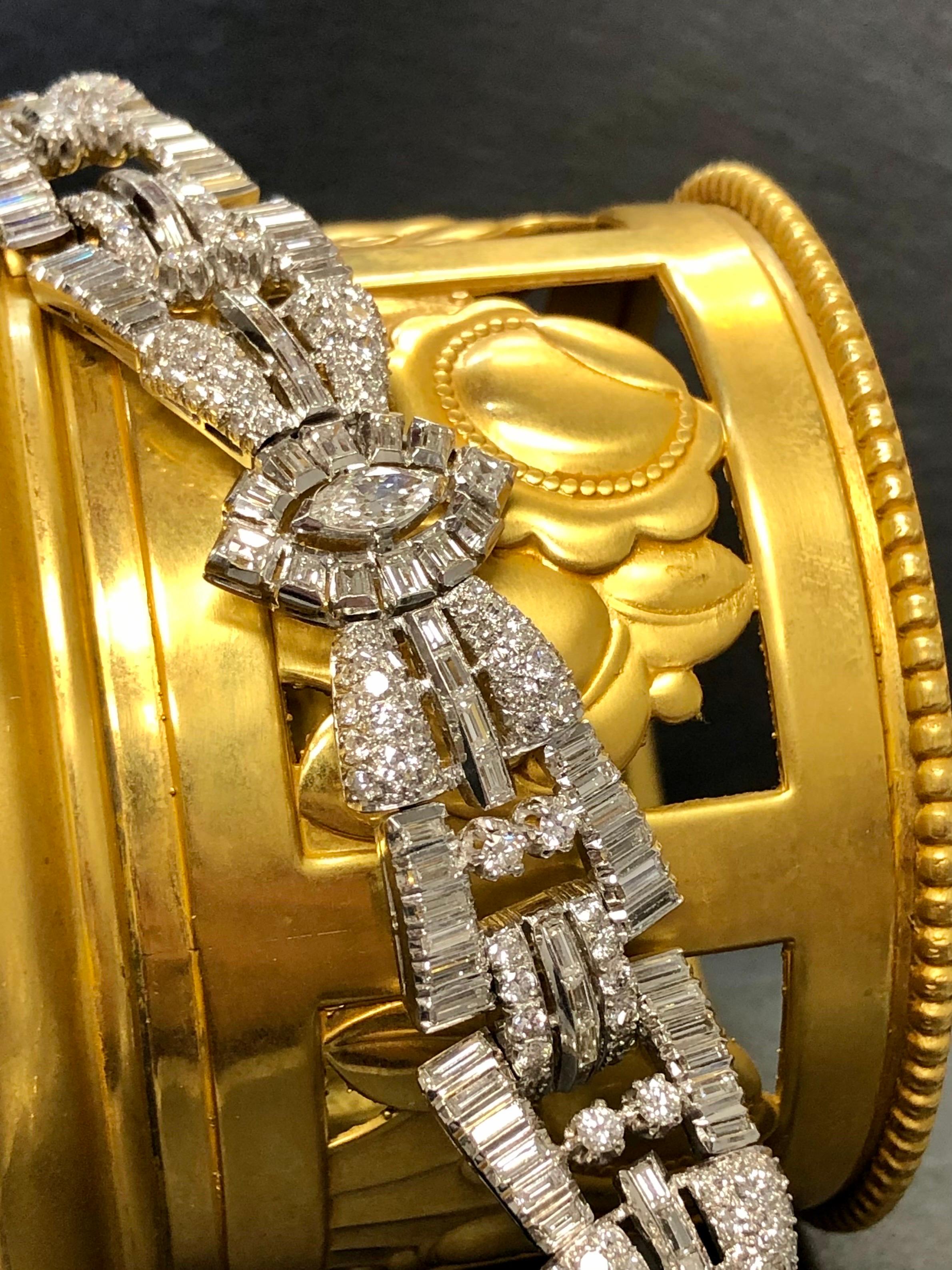 A stunning 1950’s bracelet done in platinum set with approximately 15.60cttw in larger Marquise diamonds as well as numerous baguette and round diamonds all being G-H color and Vs1-2 clarity.

Dimensions/Weight
Measures 7” long by .75” wide. Weight