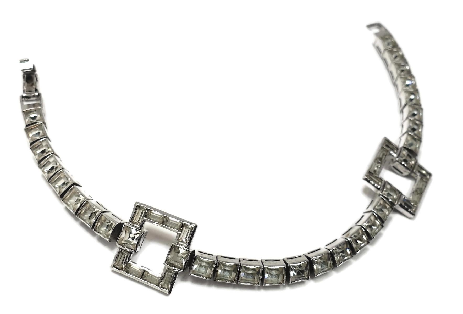 This 1950s vintage retro bracelet features clear crystals in a rhodium silver tone setting.  In excellent condition, this bracelet measures 7” x 5/8” with a fold-over clasp.