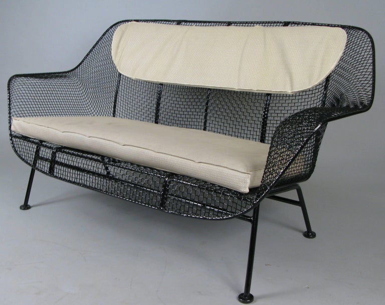 A 1950s wrought iron and steel mesh settee from Russell Woodard's classic and iconic Sculptura series. Beautiful and classic sculptural design, finished in black, but can be finished in any color you choose. Cushions not included but can be custom