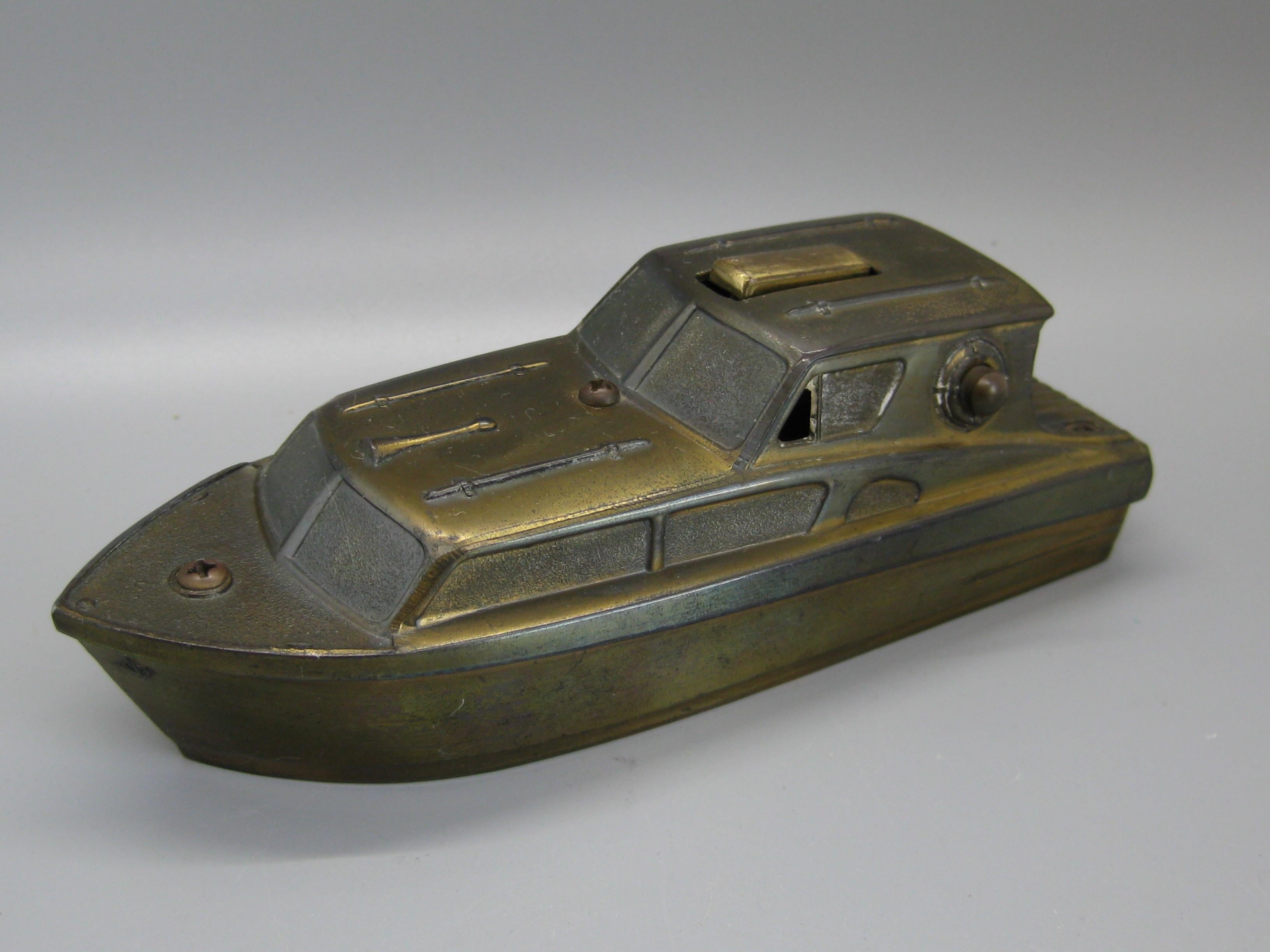 Vintage yacht or boat nautical figural table lighter dating from the 1950s. Has a push button on the side that lights the lighter. Works as it should. In the shape of a yacht or boat and is a must for any sailor or yacht owner. Made of metal and has