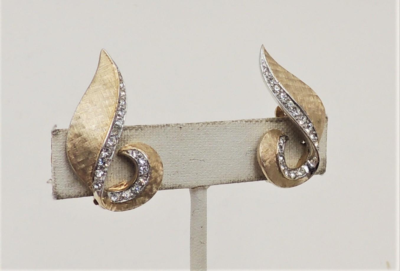 Goldtone Florentine finish clear rhinestone swirl clip earrings. Marked with inventory number 