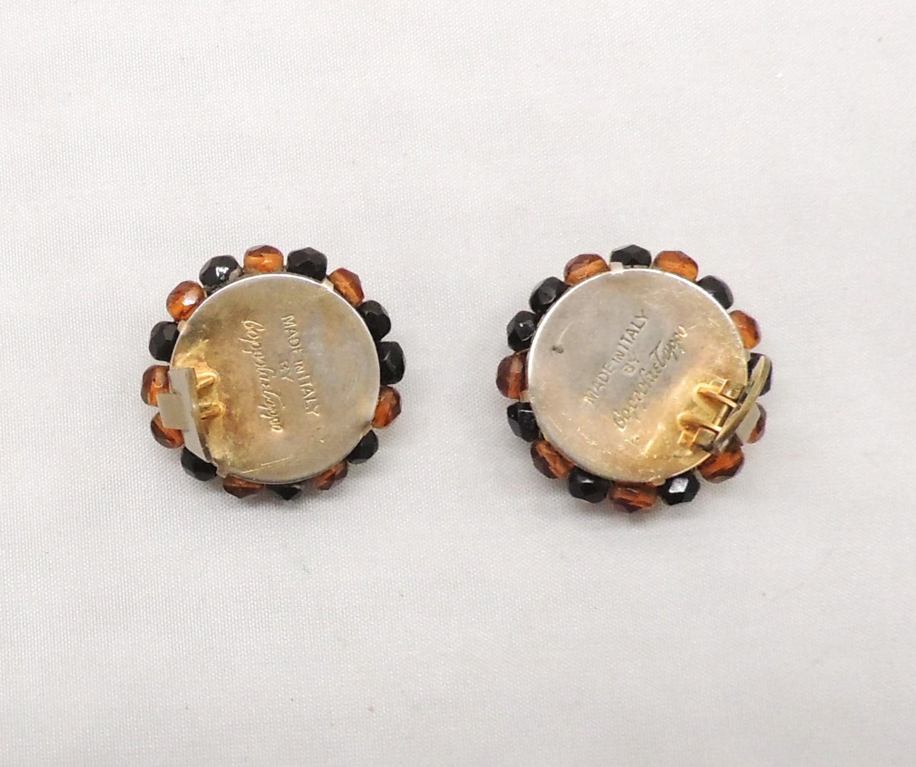 1950s round goldtone brown and black beaded clip back earrings. Marked 
