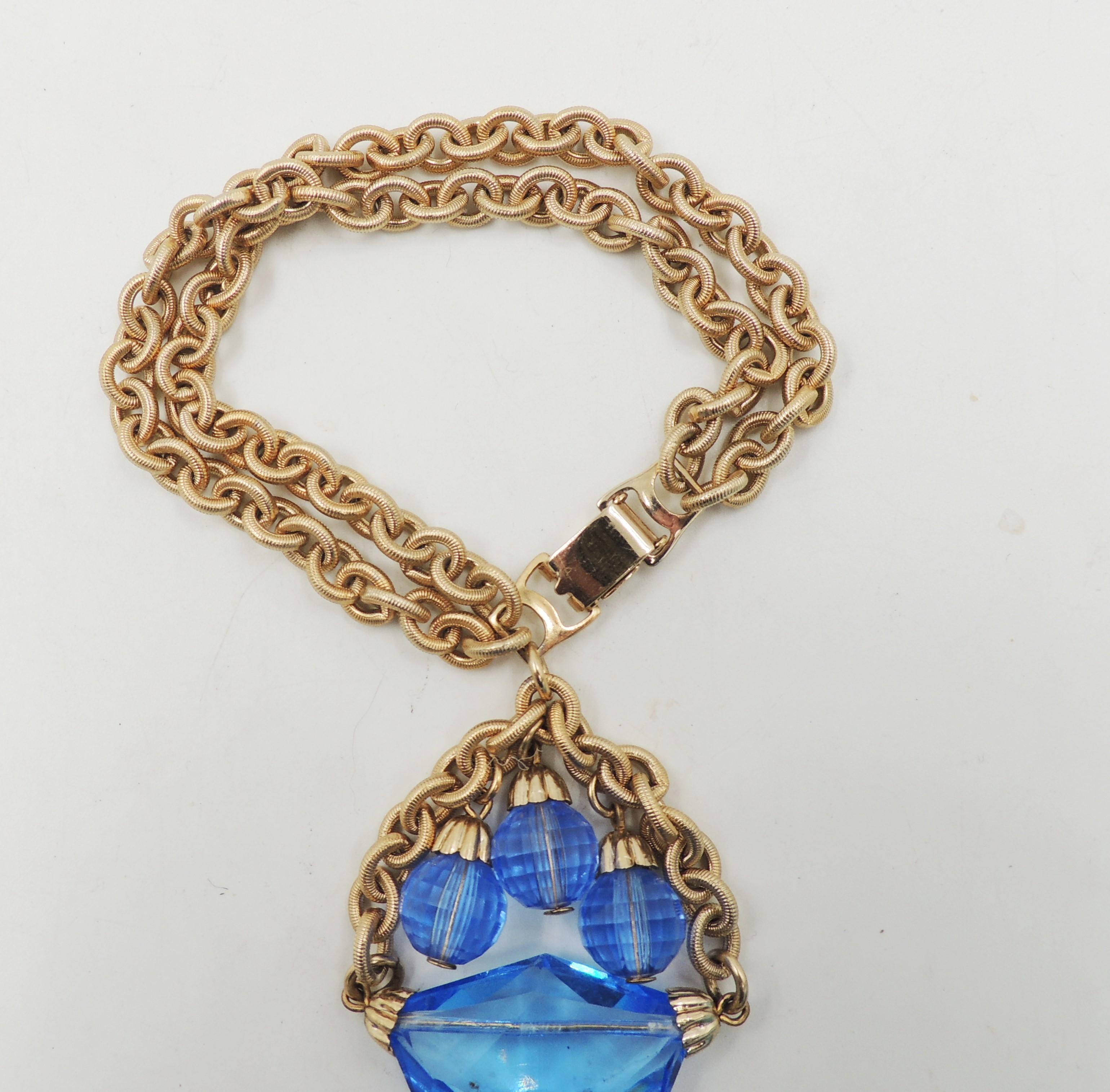 1950s goldtone cut blue glass with three faceted resin beads charm bracelet with fold over clasp. Marked 
