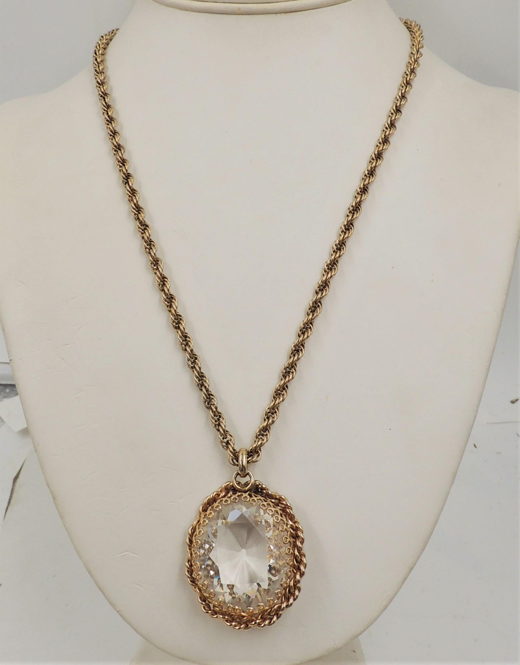 1950s goldtone filigree large faceted unfoiled open-backed clear rhinestone pendant necklace with security clasp. Marked 