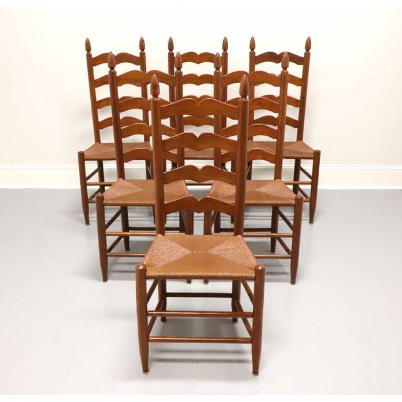 A set of six mid-century Cottage style dining side chairs, unbranded, similar quality to Henkel Harris. Made in the USA, circa 1950's. Solid cherry with ladderback design, rush seats, and turned legs.

Measures: Overall: 19.5W 15D 45.25H, Seat: