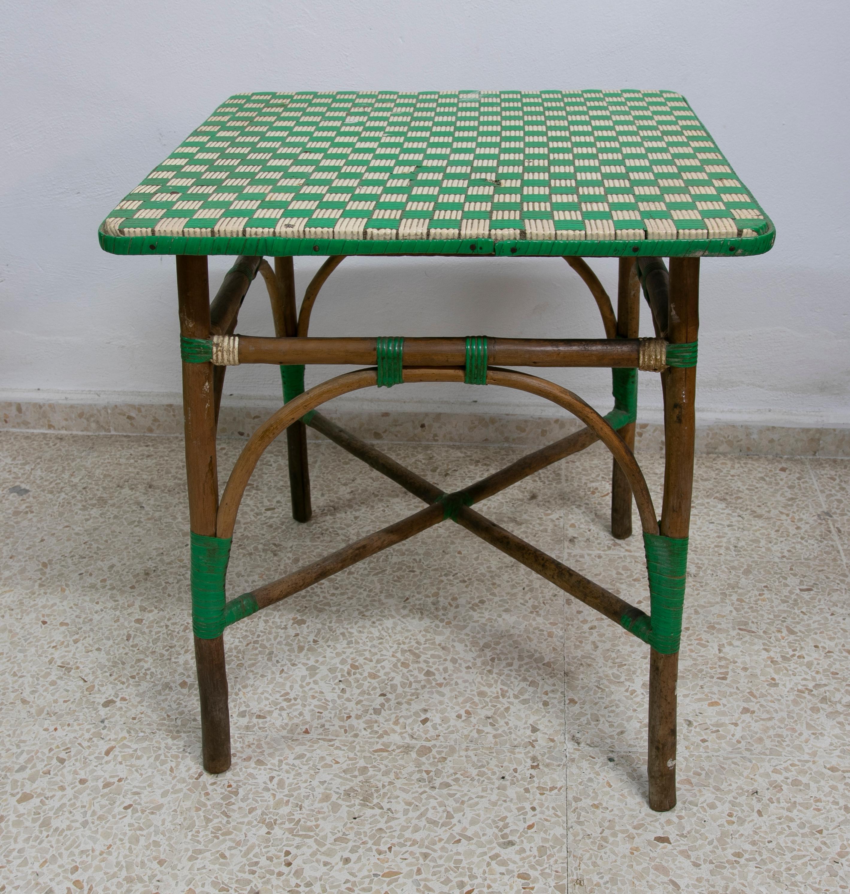 Vintage 1950s Spanish bamboo side table with 2-tone woven fibers decorated top.