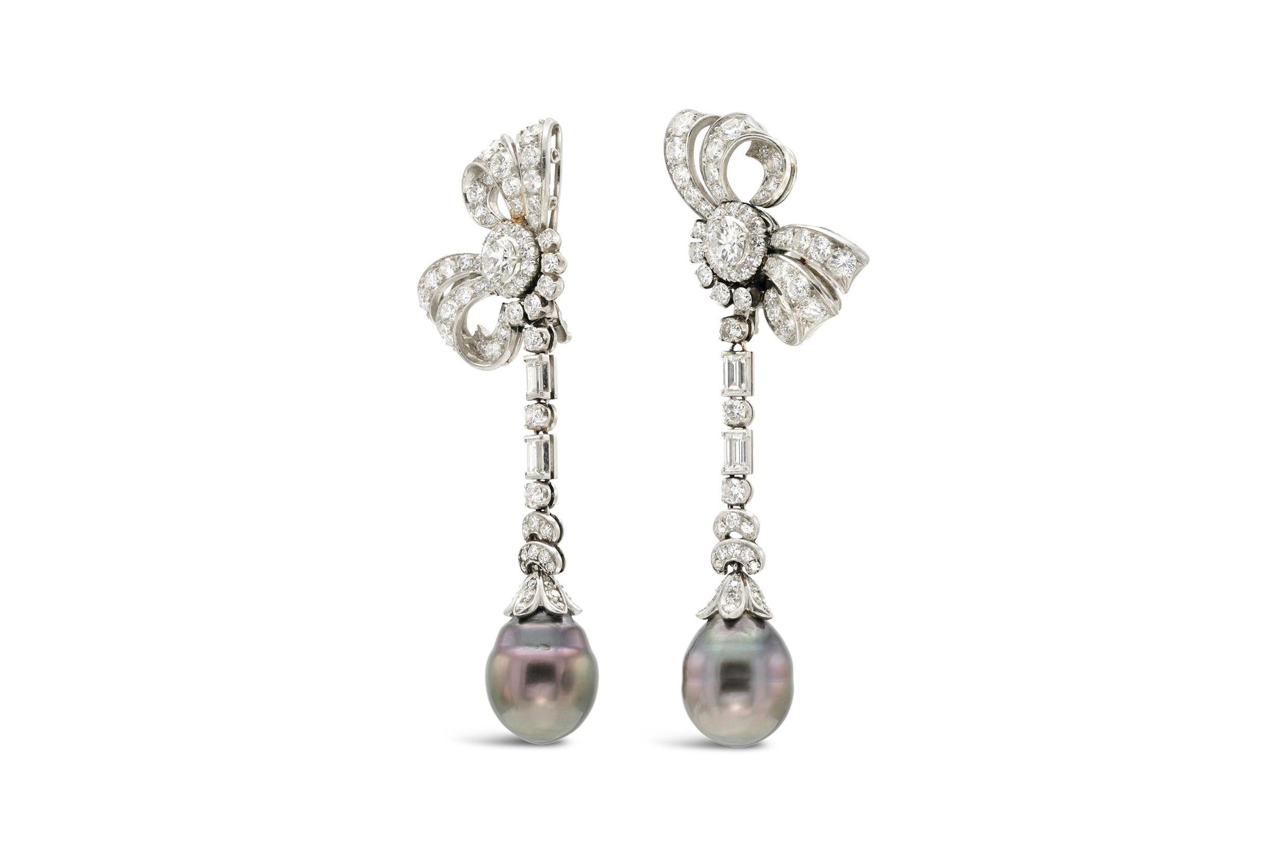 Finely crafted in platinum with two Tahitian Pearls measuring 10.7 x 13 mm and 10.3 x 13 mm.
The earrings feature 2 Round Brilliant cut center Diamonds weighing approximately a total of 0.70 carats, 124 Round cut Diamonds weighing approximately a