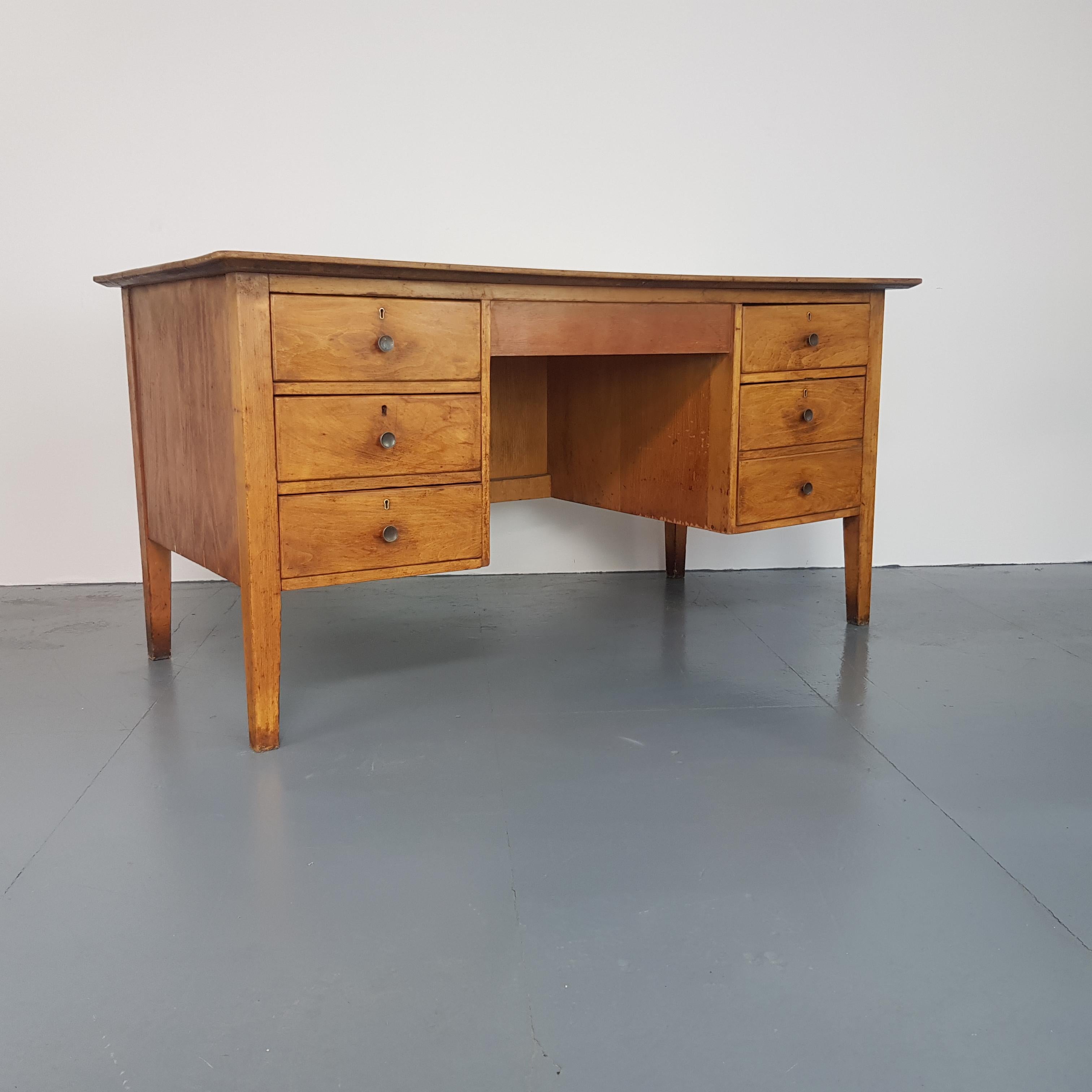 Vintage beech 1950s teacher's desk.

Double pedestals with three drawers on each side.

In vintage condition - this piece comes from a school and as such, has signs of wear and tear commensurate with age i.e bumps, scuffs etc, all adding to the