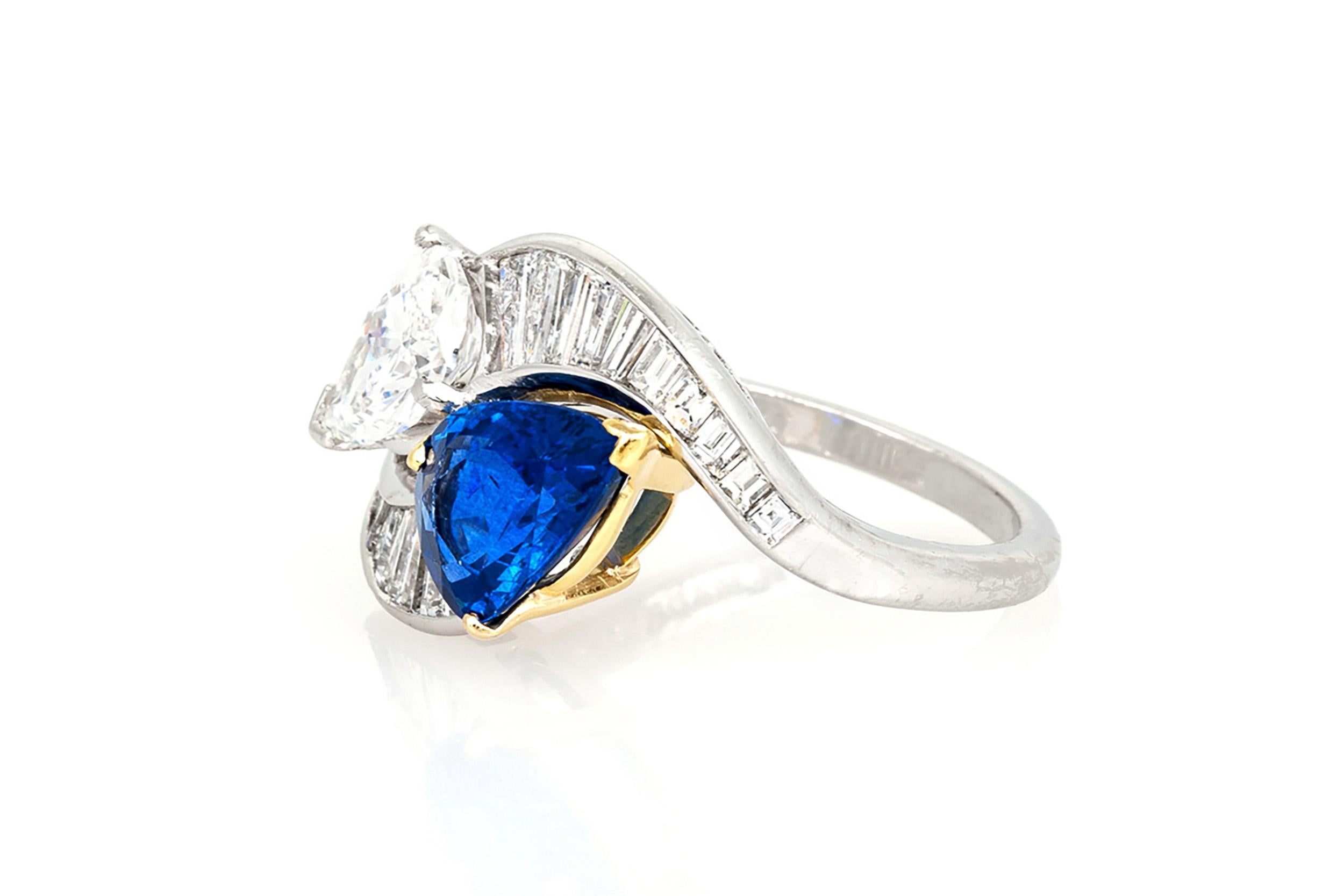 Finely crafted in platinum and 18k yellow gold with a Pear-Shaped Sapphire weighing approximately 2.50 carats, and a Pear-Shaped Diamond weighing 1.18 carats, G color, VS1 clarity. The ring features Baguette cut Diamonds weighing a total of