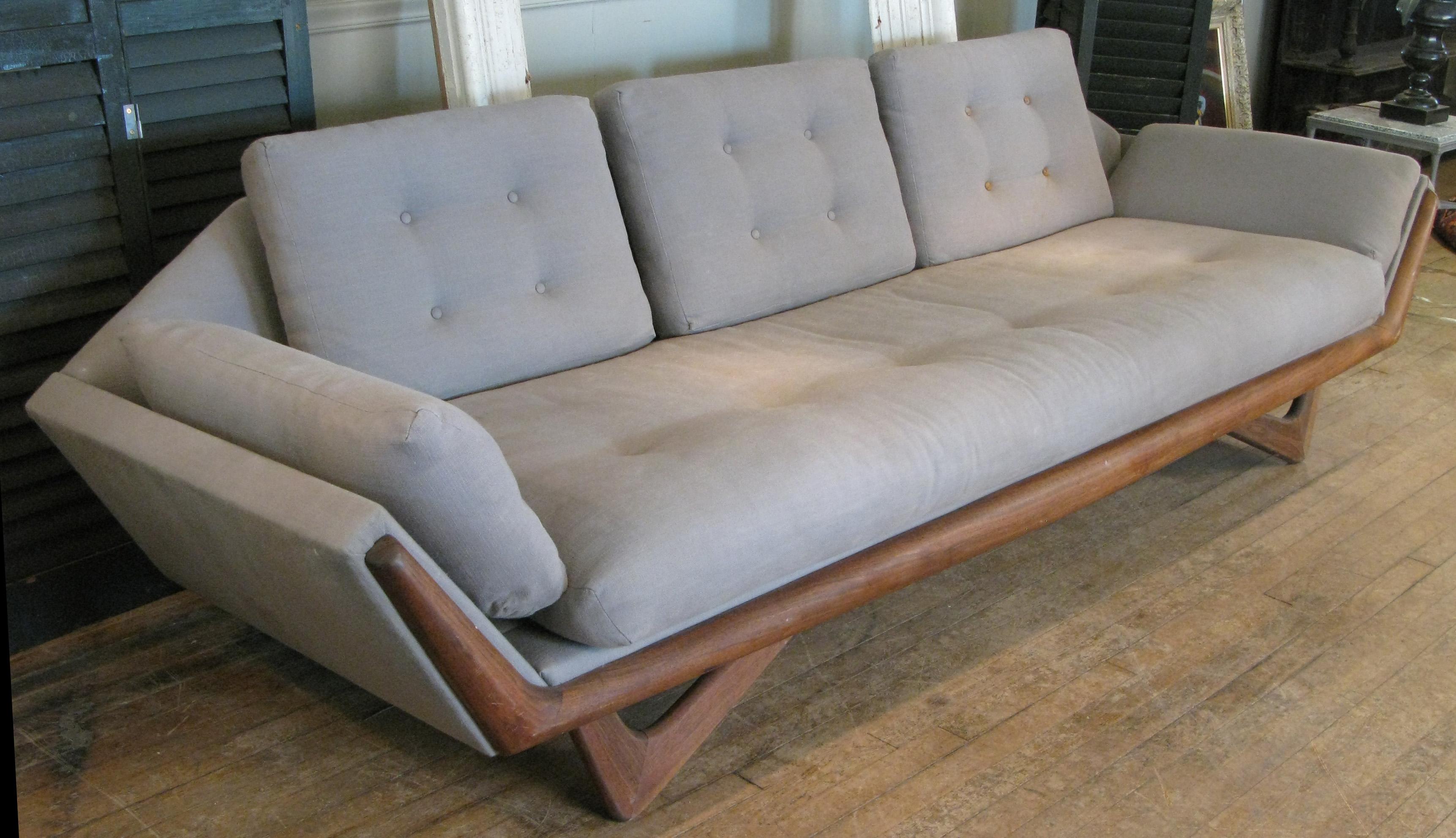 A Classic and beautiful 1950s three-seat gondola sofa designed by Adrian Pearsall for Craft Associates with walnut base. one of his most iconic and recognizable designs, with angled front legs and a wide walnut band along the front of the frame.