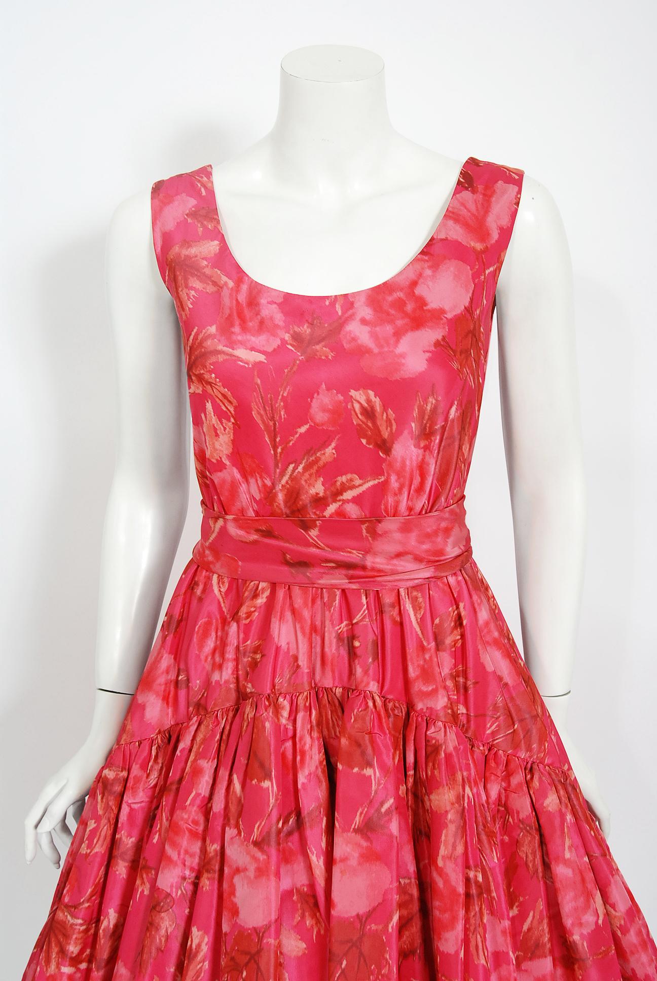 In this gorgeous 1950's rose-pink party dress, the detailed construction and meticulous attention to detail are comparable to what you will find in modern couture. The garment is fashioned in high quality mid-weight silk taffeta with the prettiest
