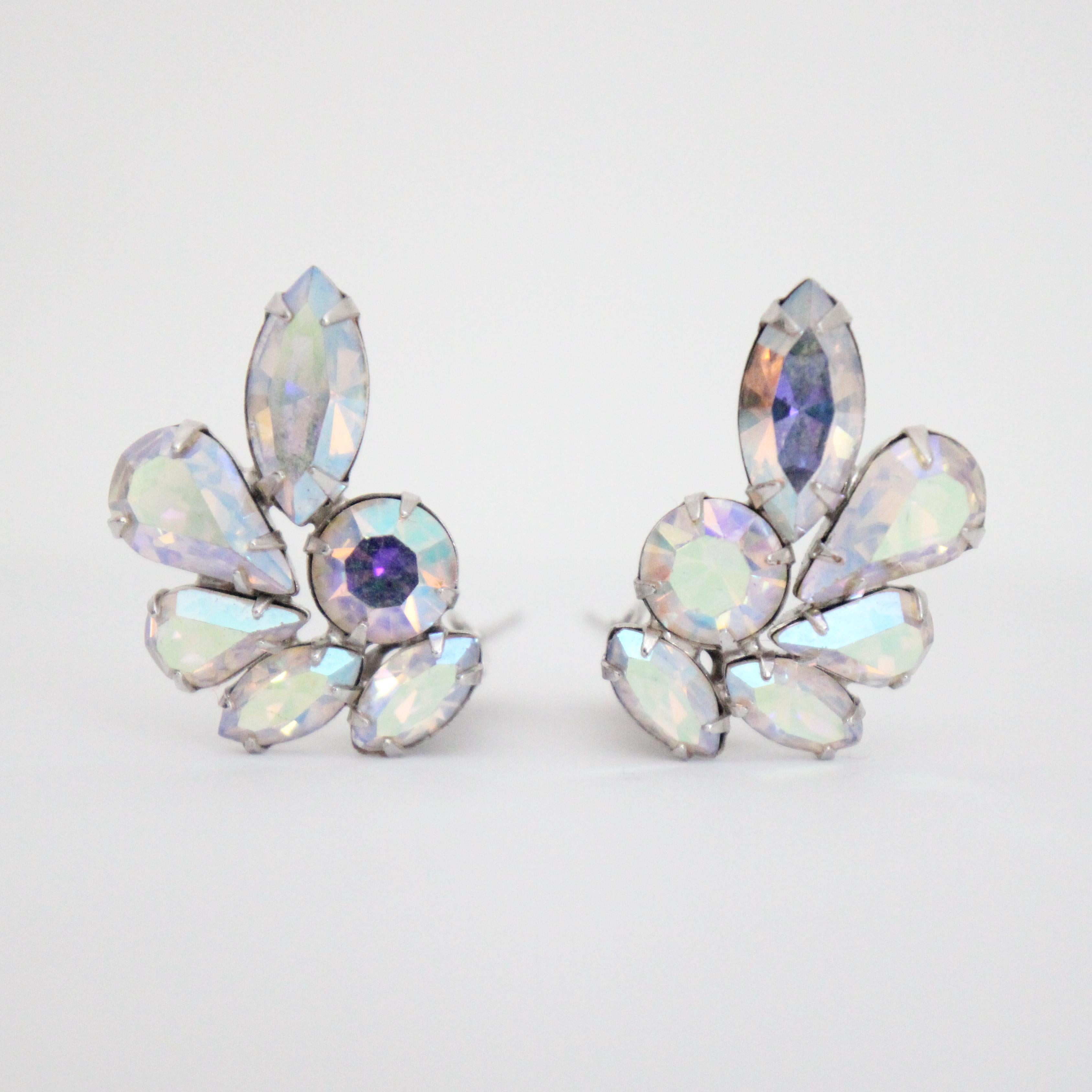 This breathtaking pair of 1950's clip on earrings, on silver toned metal bases, made up of teardrop and petal cut iridescent rhinestones, surrounding a central iridescent rhinestone, in an open floral design, are the perfect touch of sparkle to your