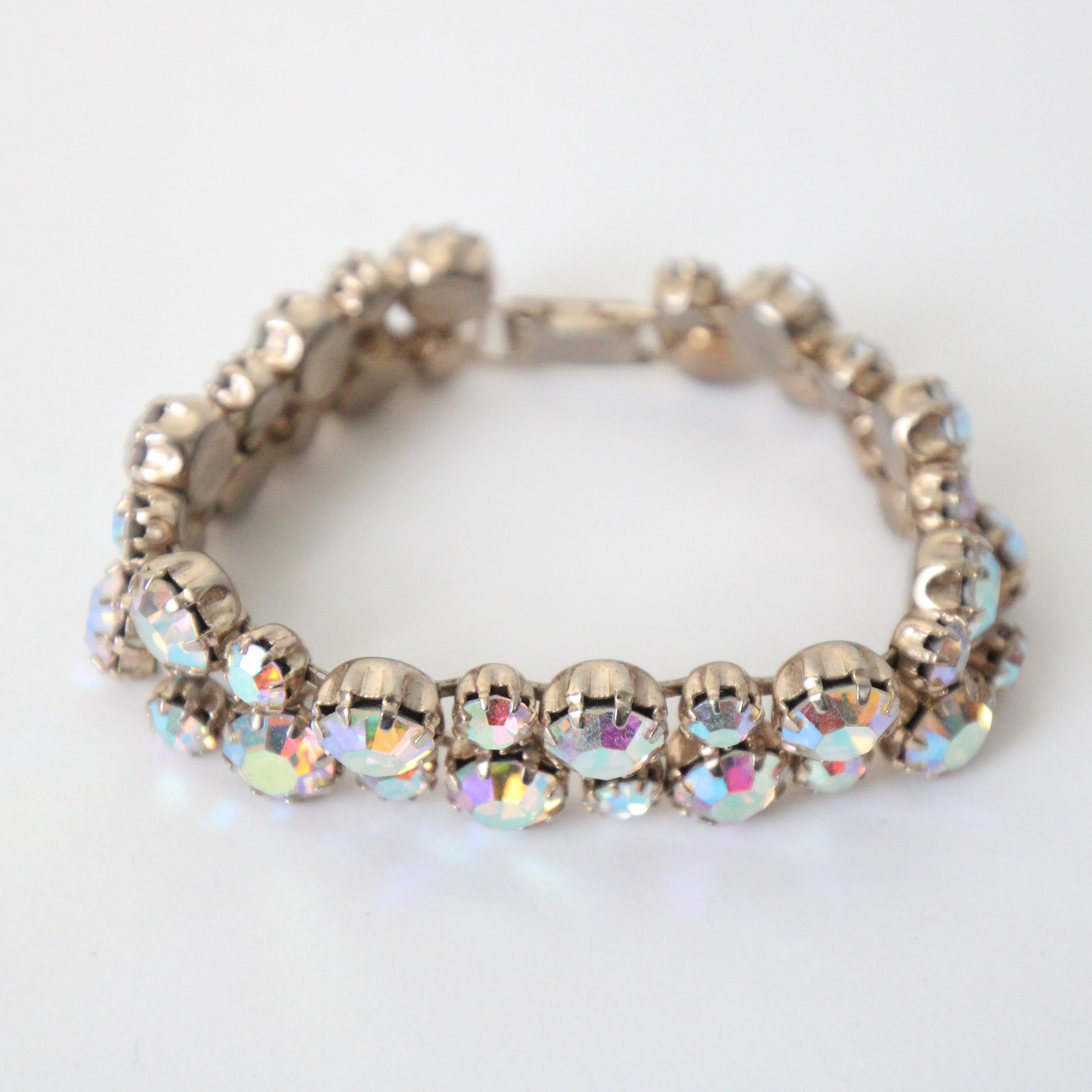 This spectacular vintage 1950's Weiss rhinestone bracelet made up of large claw set round rhinestones interspersed with some claw set round rhinestones, on a silver toned metal base, is the perfect touch of sparkle to complete any outfit.

Length of