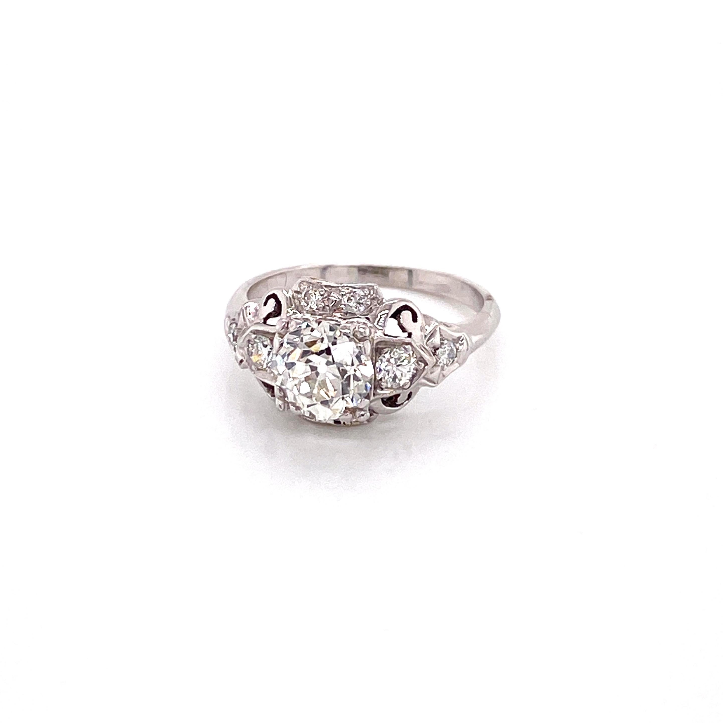 Vintage 1950s White Gold European Cut Diamond Filigree Ring - The center Old European Cut diamond weighs 1.20ct and is an I color and SI1 clarity. The diamond is set prominently in square fishtail prongs with 8 full cut diamonds accented on the