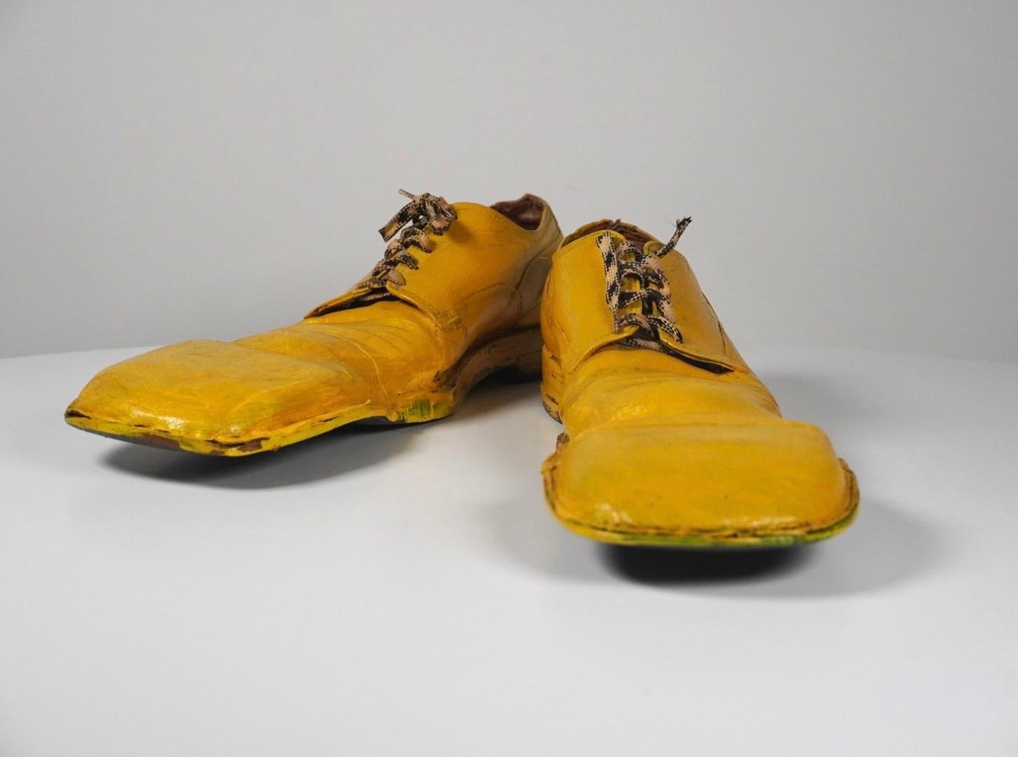 Handmade clown shoes from the 1950s in yellow leather, with lots of patina from years of use. These were a custom made shoe from a existing pair of regular street dress that have been modified to create these shoes. Because of the limited nature of
