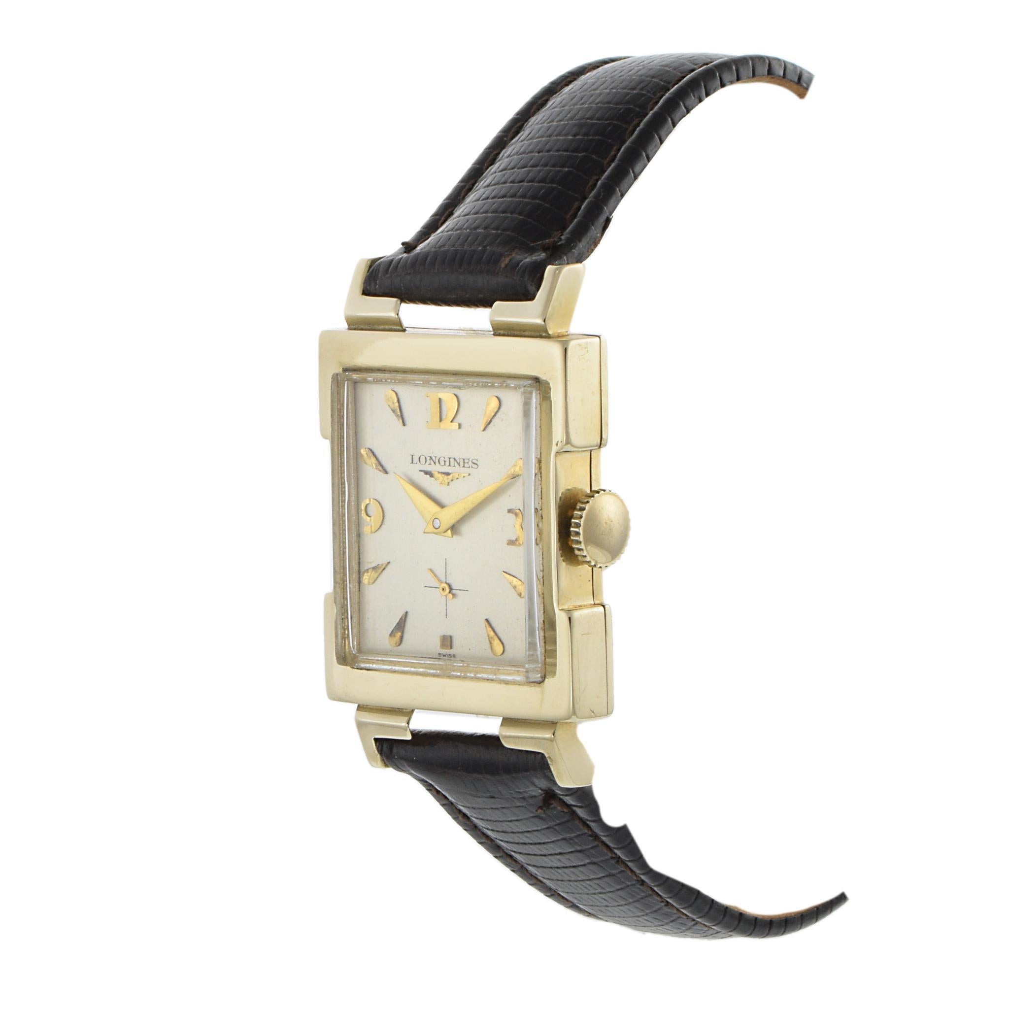 A refined 1955 Longines dress watch featuring a 25.5 x 28.5mm rectangular 14K yellow gold case crafted by L&K. The silver dial is accented with raised gold markers and a sub-dial for seconds, offering a timeless and elegant aesthetic. Powered by a