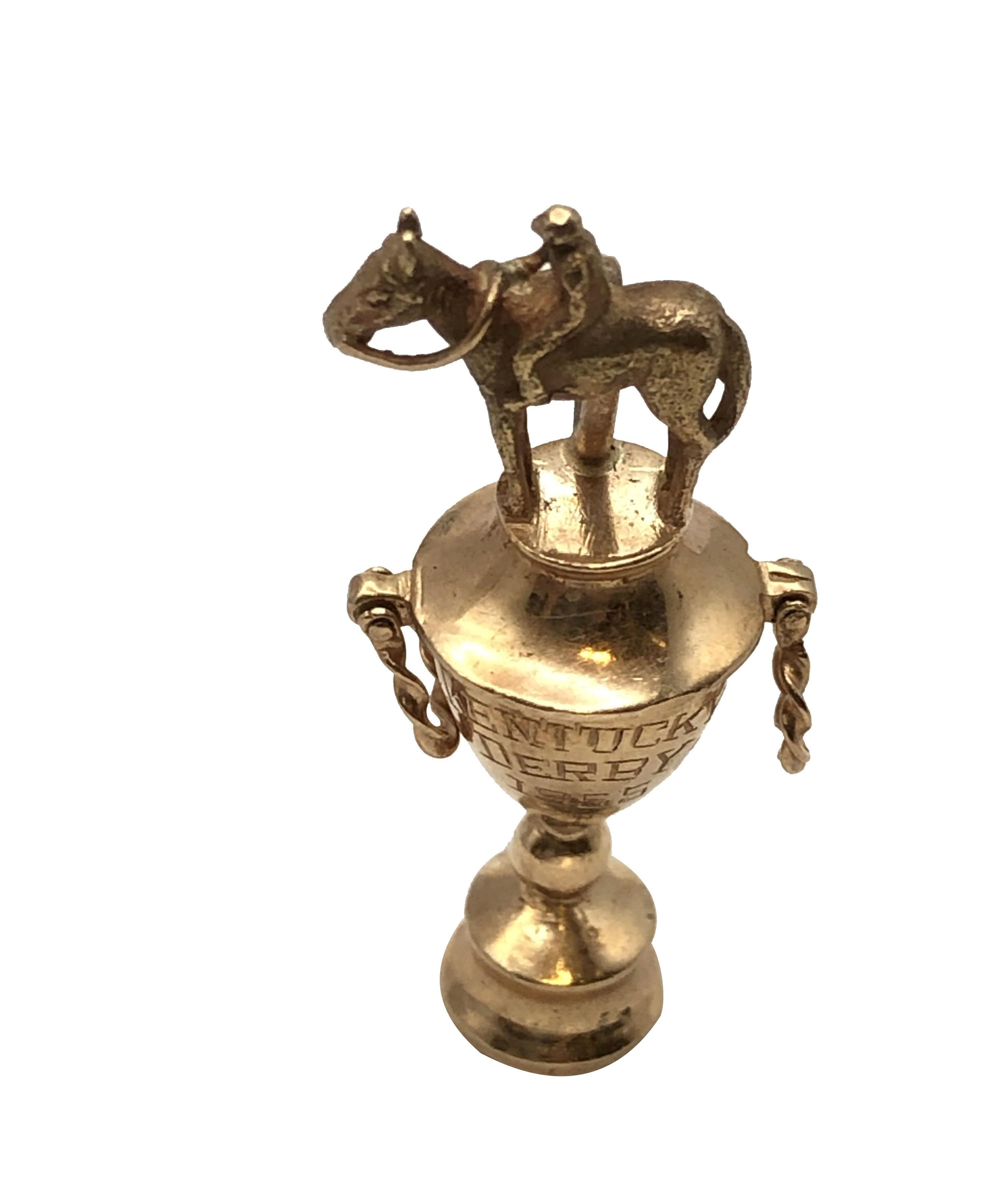 Circa 1955 14k  Yellow Gold Kentucky Derby Horse Trophy Form Charm, measuring  1 3/8 inches in height, 1/2 inch wide and weighing 12.5 Grams. This very Unique piece is incredibly well detailed, the trophy handles are separately attached and have
