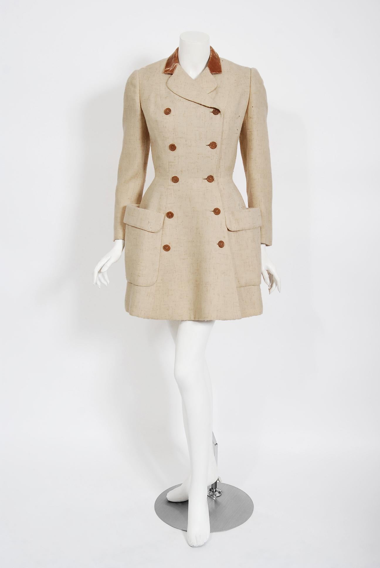This exquisite 1955 Traina-Norell designer jacket, in mid-weight oatmeal beige wool tweed, exemplifies their signature blend of couture-level quality with quintessentially American style—elegant in its simplicity. A very similar garment was