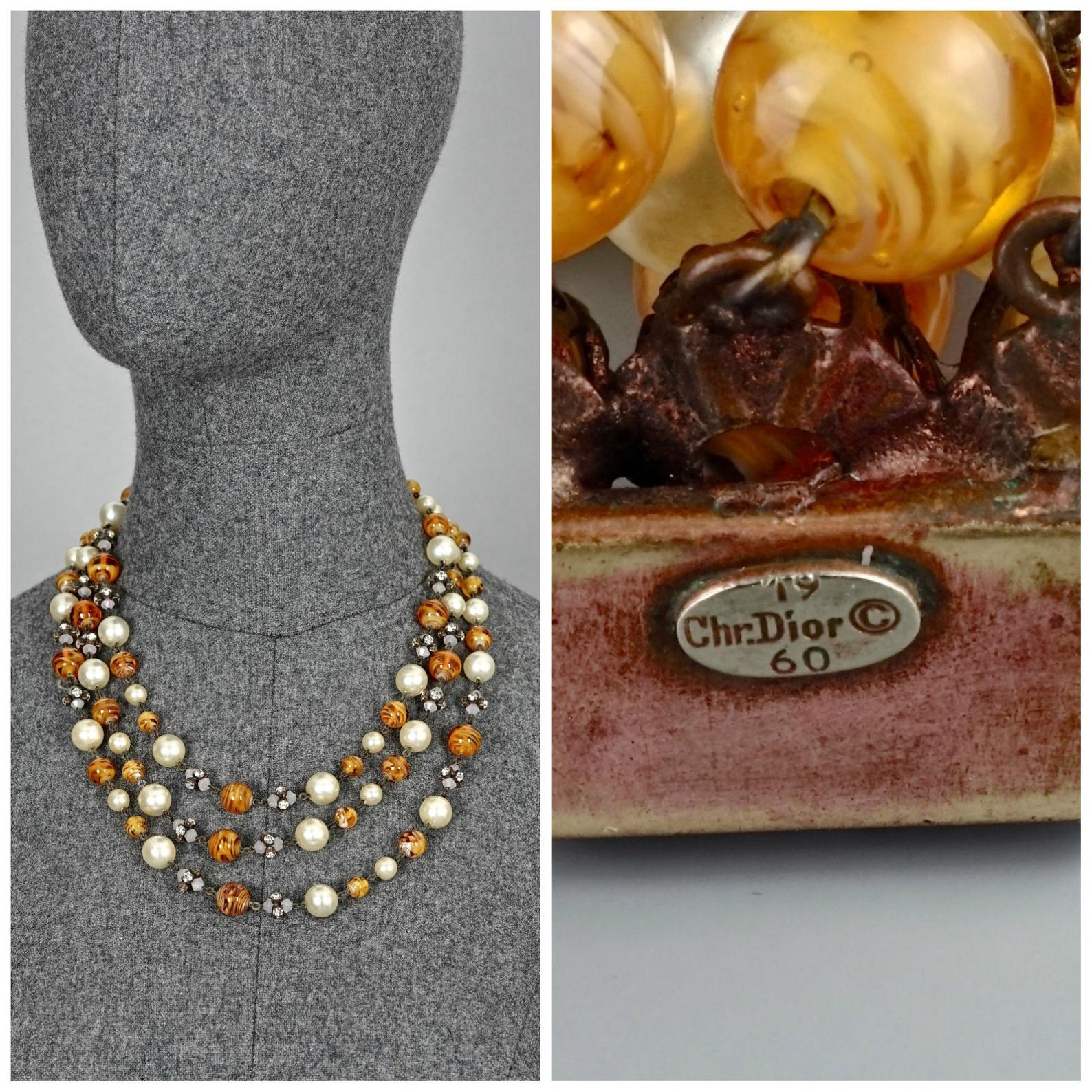 Vintage 1960 CHRISTIAN DIOR Triple Strand Amber Glass and Pearl Necklace

Measurements:
Height: 1.97 inches (5 cm)
Wearable Length: 25 inches (49.5 cm)

Features:
- 100% authentic CHRISTIAN DIOR.
- 3 tiered/ strand of glass pearls , glass beads and