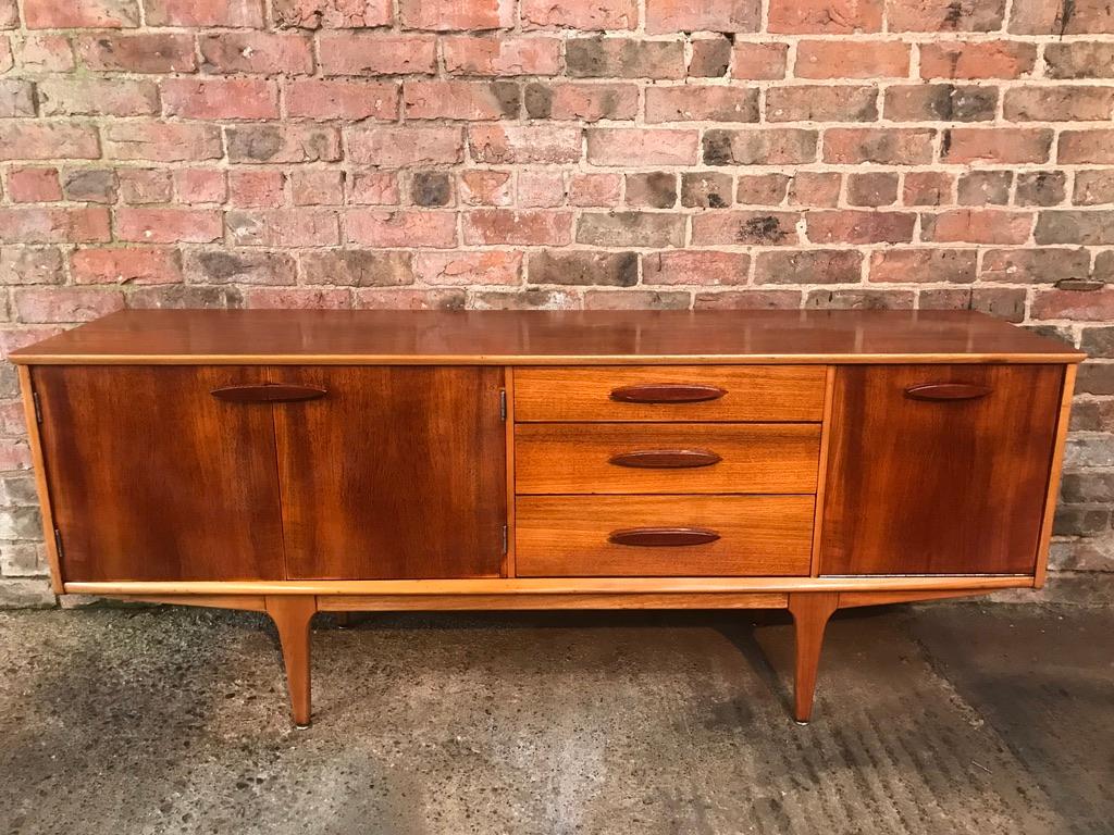 Lovely vintage teak sideboard or credenza, 1960s. It has three drawers, cupboard space and a drink section

Measures: Height 74cm, depth 45cm, width 183cm.