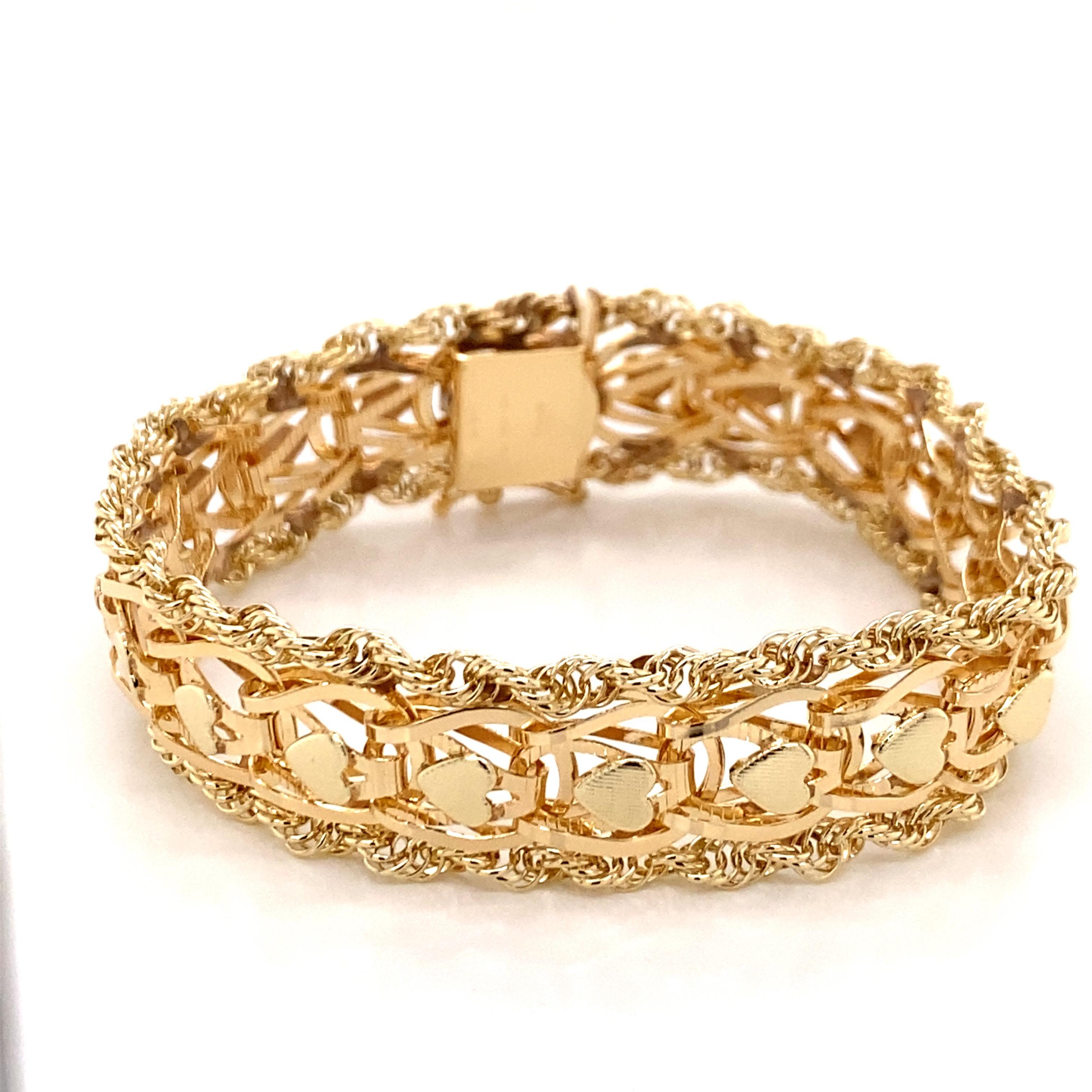 Vintage 1960s 14 Karat Yellow Gold Heart Shape Link Bracelet with Rope Edge - The bracelet measure 7.25 inches long and 1/2 inch wide and features a hidden clasp with a figure 8 safety. The bracelet weighs 23.5 grams.