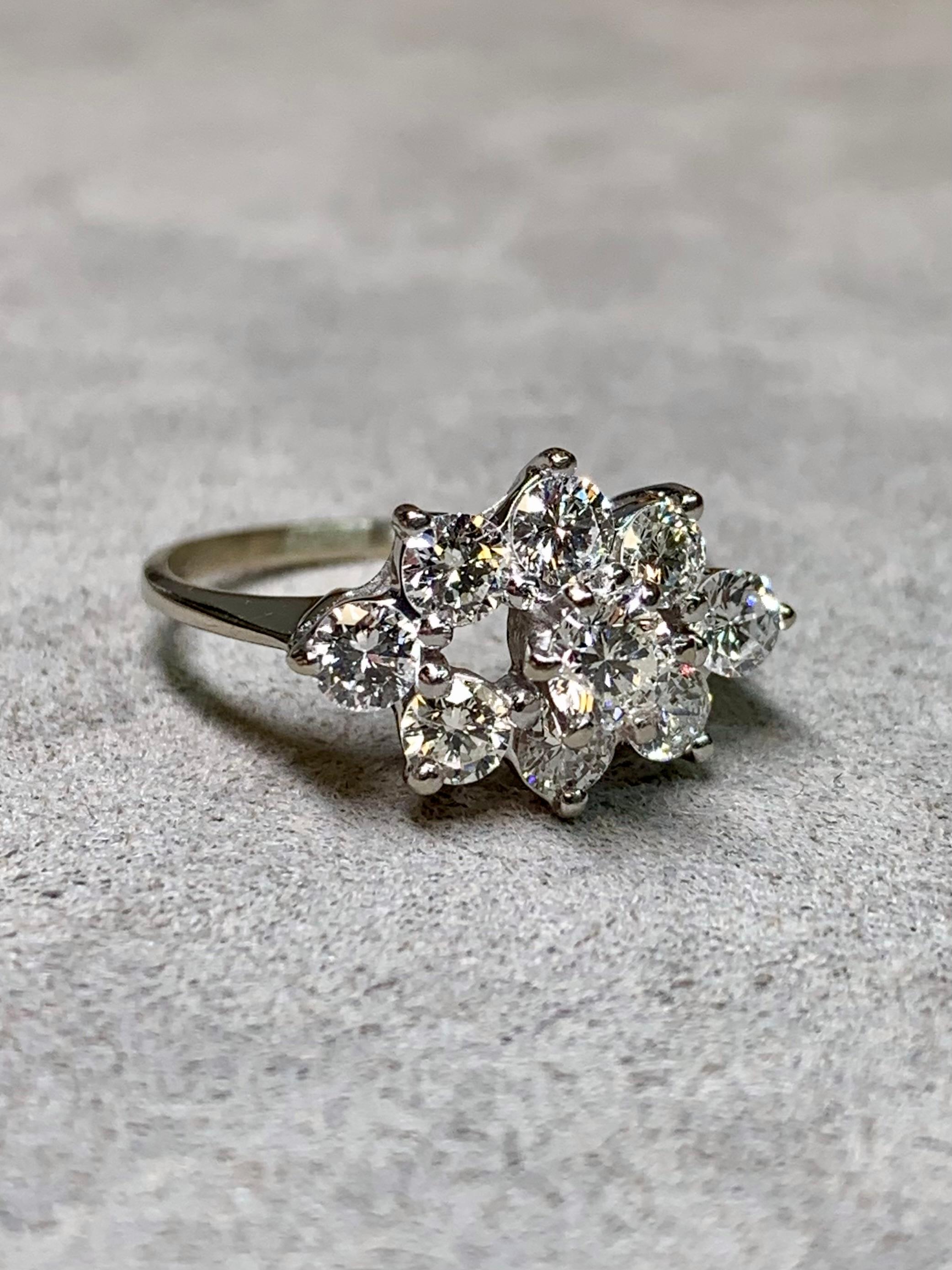 Ein Vintage-Ring aus den 1960er Jahren, gefertigt aus 14 Karat Weißgold und mit neun Diamanten im Brillantschliff besetzt. Die Diamanten wiegen im Durchschnitt jeweils etwa 0,15 Karat, der Mittelstein über 0,30 Karat. Insgesamt belaufen sich die