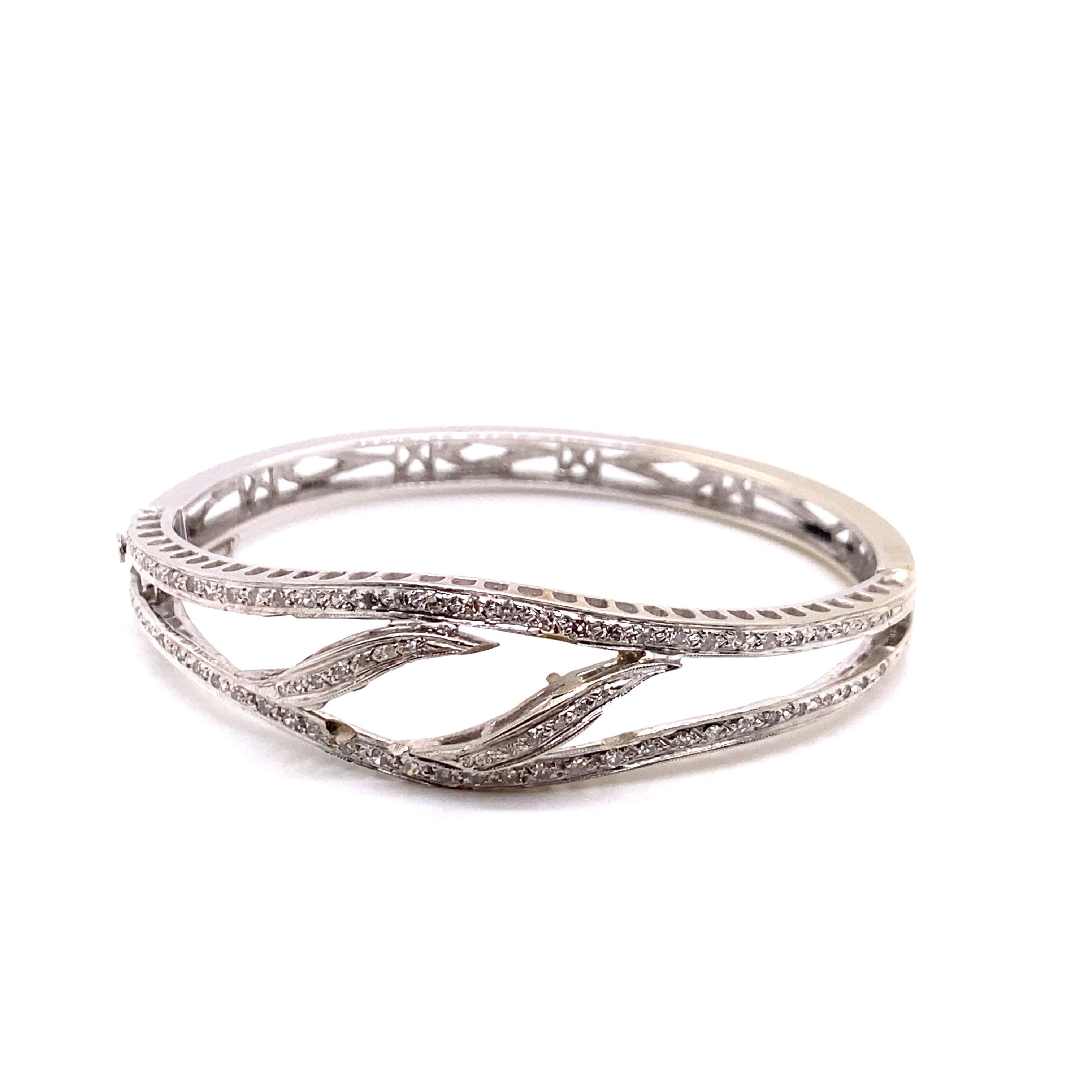 Vintage 1960's 14K White Gold 2 Row Diamond Bangle - The bangle contains 76 single cut diamonds with a total approximate weight of 1.00ct. The width of the bangle in the center is 15.7mm and tapers down to 5.6mm on the bottom. The inside diameter is