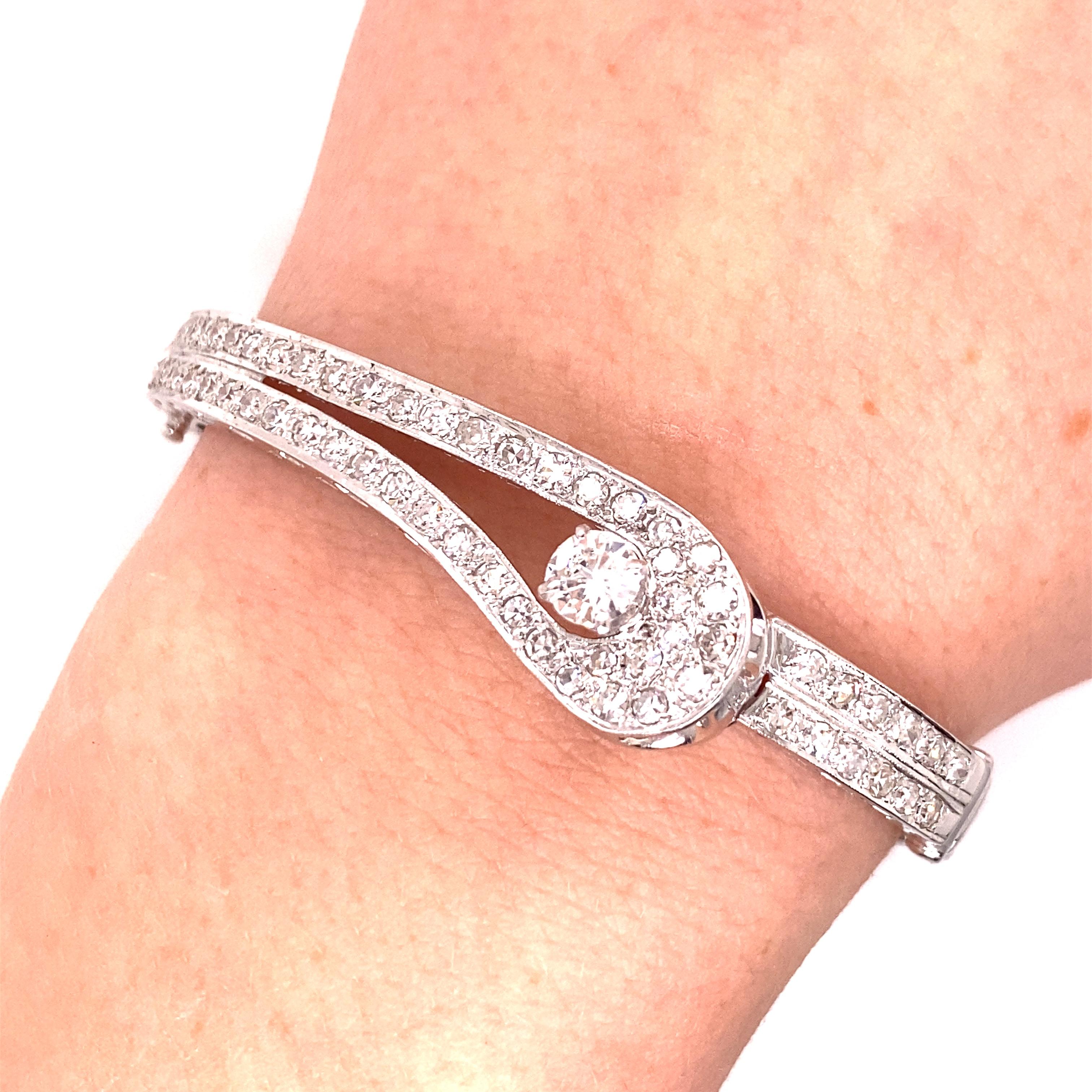 Vintage 1960's 14K White Gold Diamond Bangle - The bracelet contains one European cut diamond set in a 4 prong head which weighs about .45ct. The diamond quality is I color and VS2 clarity. There are 63 single cut diamonds pave set along the double