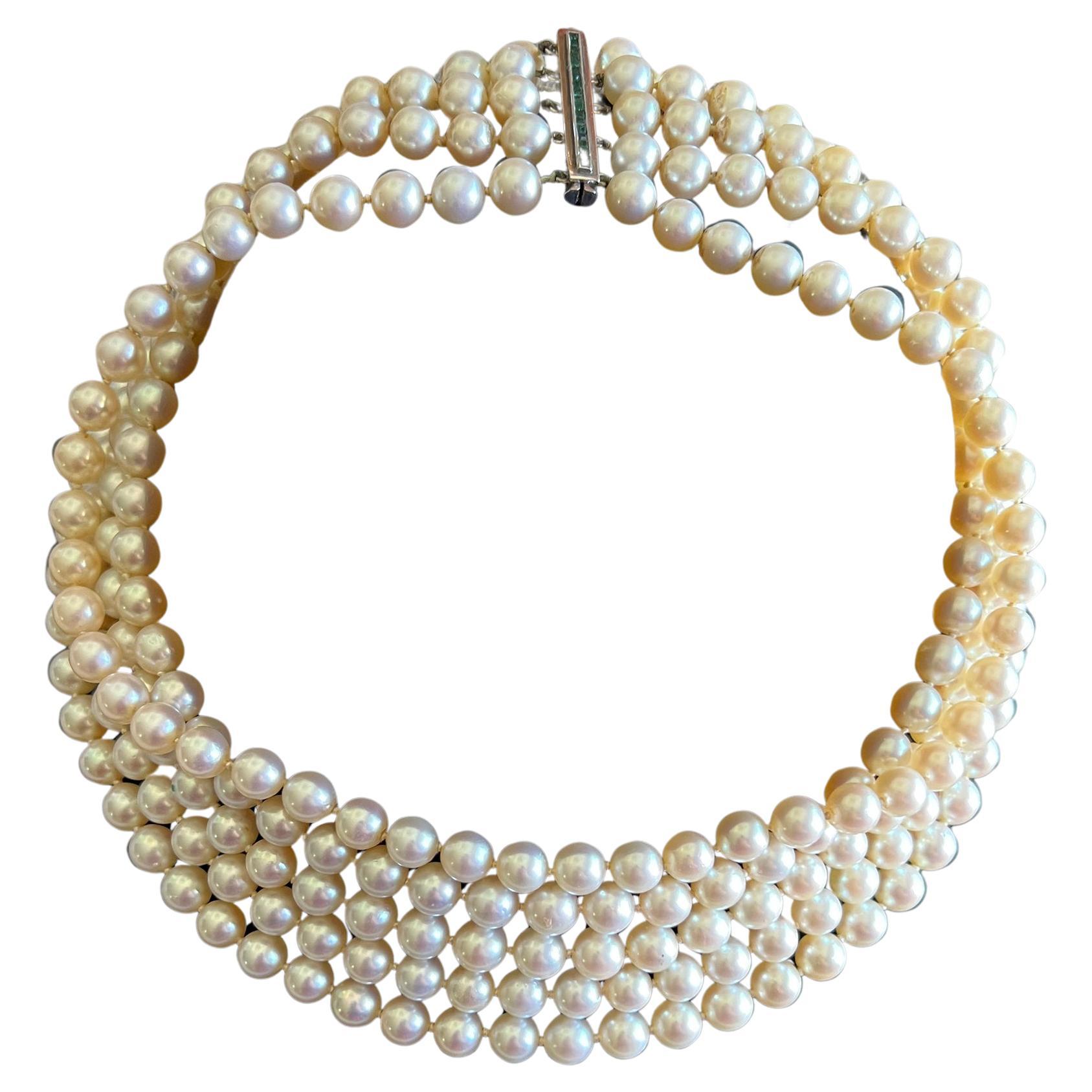 Luxurious five strand pearl necklace with 14k white gold closure containing channel set emeralds.  Emeralds do have natural inclusions and are very hard to see with the naked eye, mostly only under magnification. Necklaces shortest strand measures
