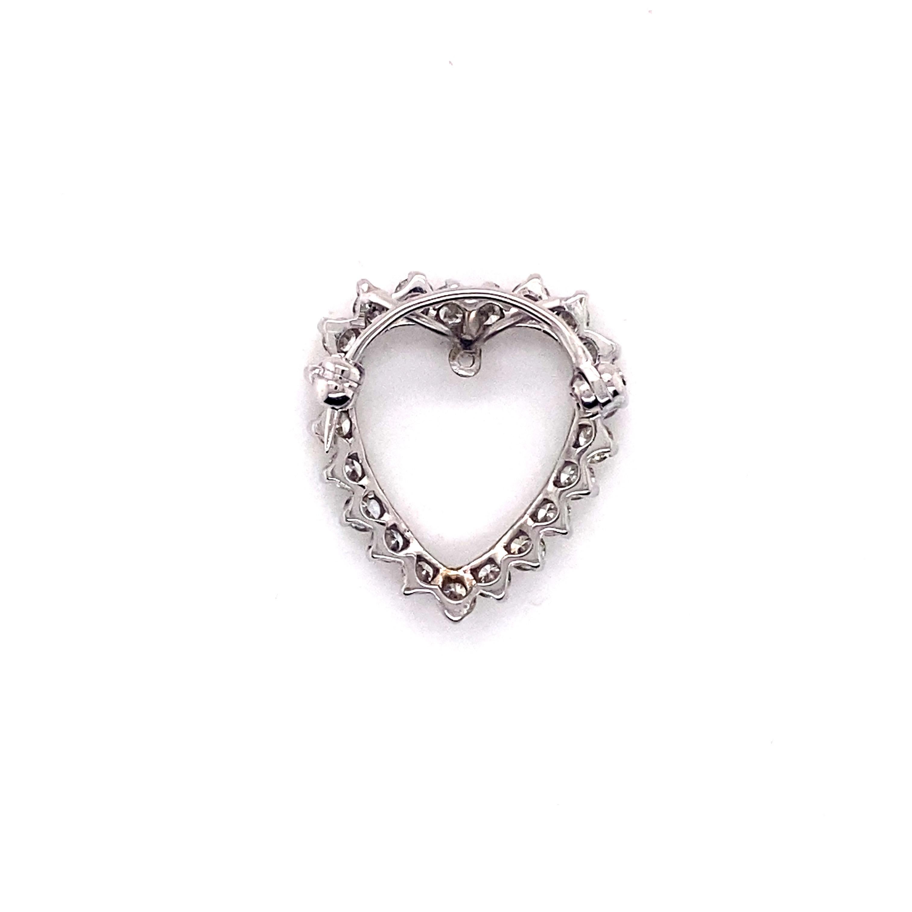 Vintage 1960’s 14K White Gold Diamond Heart Pin and Pendant. The heart contains 21 round brilliant diamonds prong set and weigh approximately 1.50ct. The diamond quality is G - H color and VS - SI clarity. The heart has a hidden double bail for a