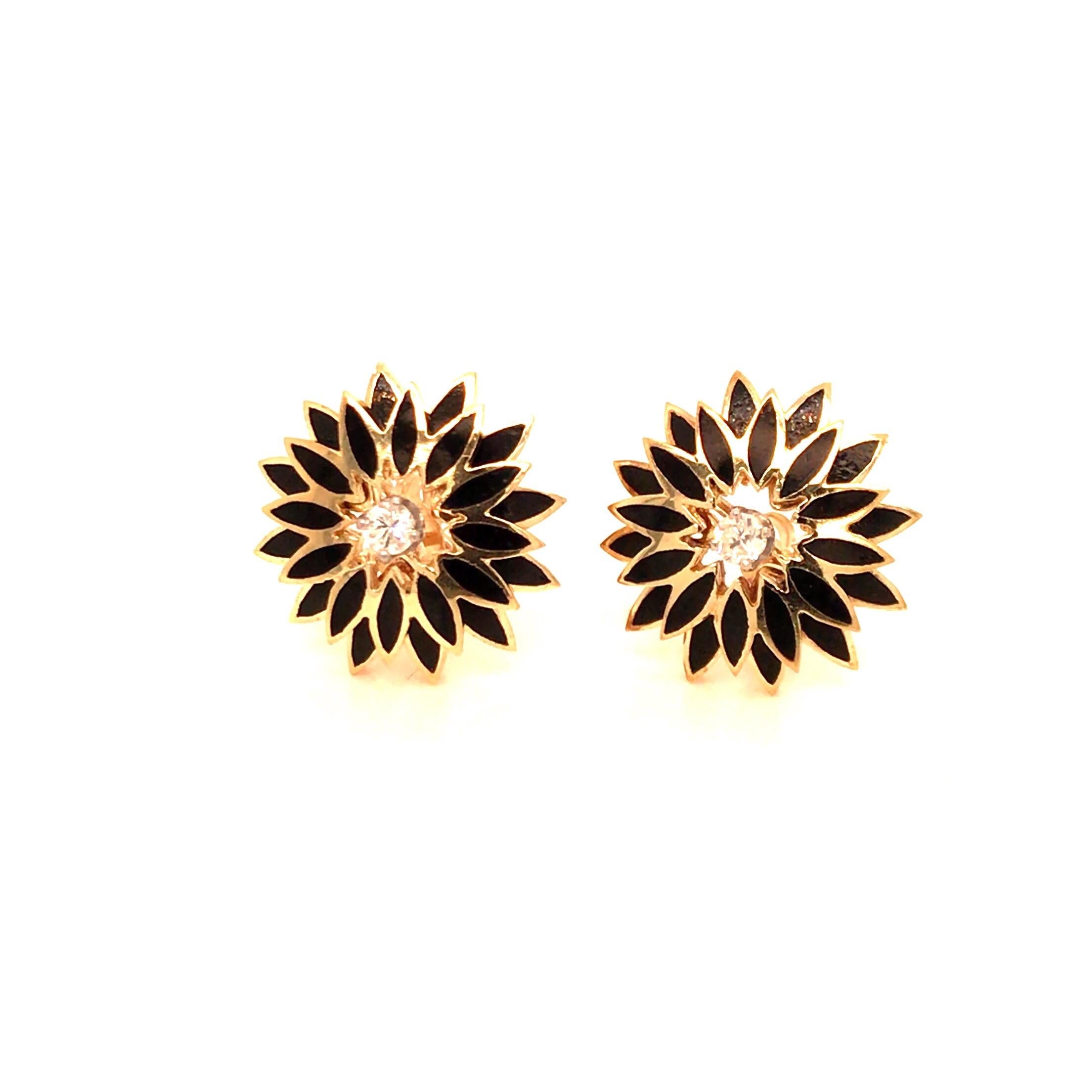 Vintage 1960's 14kt yellow gold diamond and black enameled earrings with a center round diamond in each ear weighing approximately .16ct total (H/I color, VS2/SI1 clarity) with 2 levels of 12 black enameled marquise shape sections each. 17.5mm in