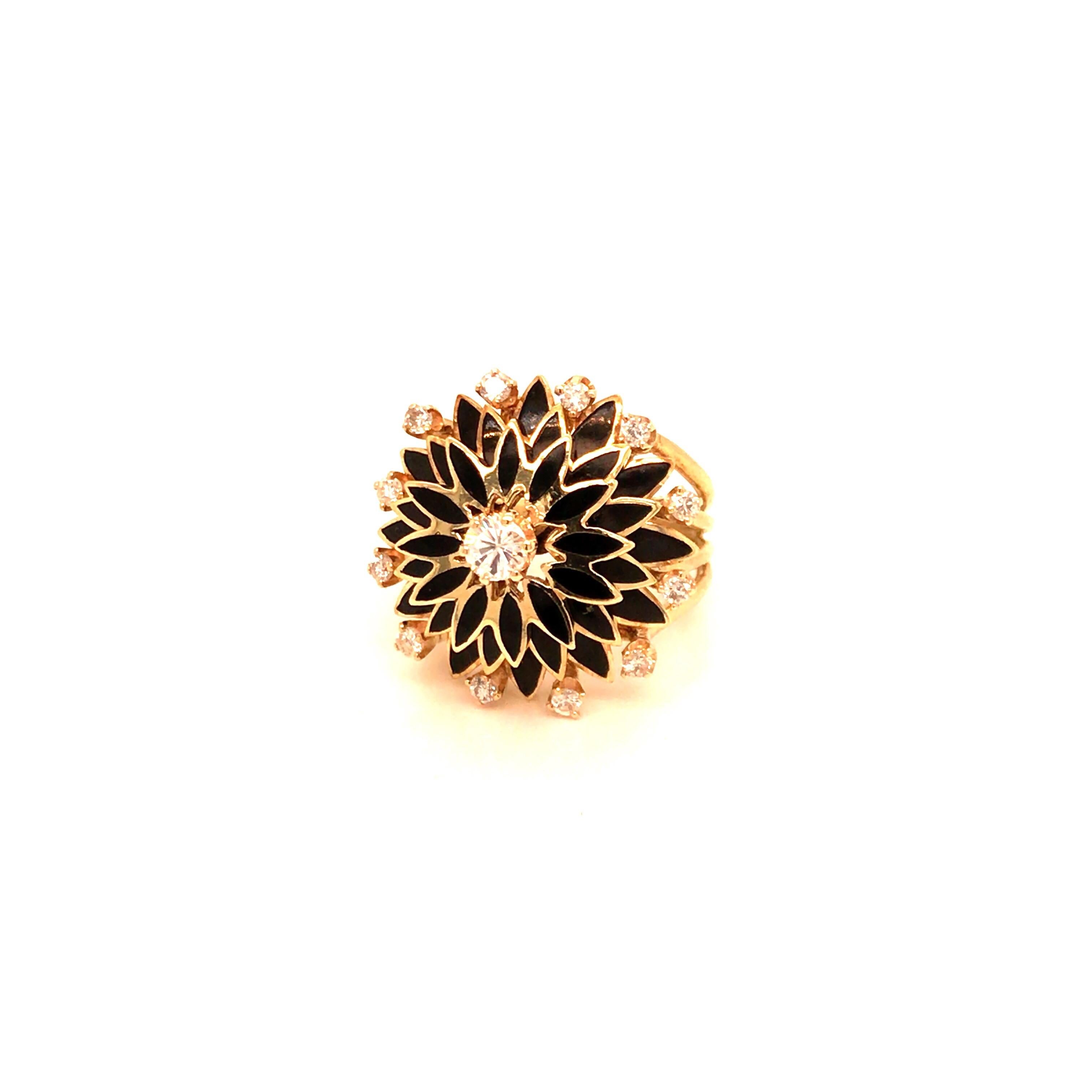 Vintage 1960's 14kt yellow gold diamond and black enameled ring with a center round diamond weighing approximately .23ct (I color, SI2 clarity) with a surrounding of 3 levels of 12 black enameled marquise shaped sections in each level with a