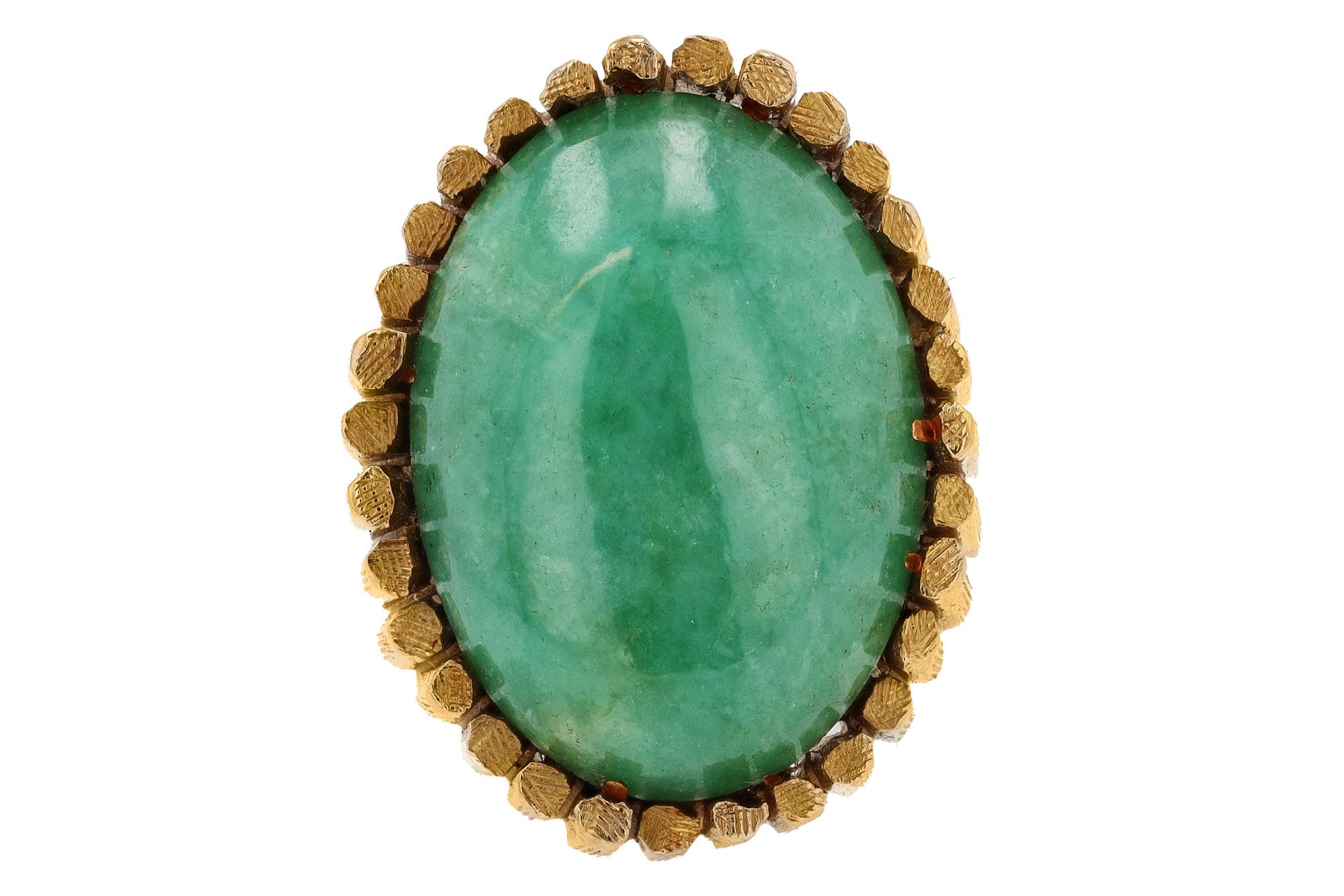 An edgy design reminiscent of volcanic basalt columns surrounds a 15 carat verdant green Jade in this modernist cocktail ring. The natural, type A Jadeite is untreated and has a delightfully refreshing apple green with mottling providing depth.